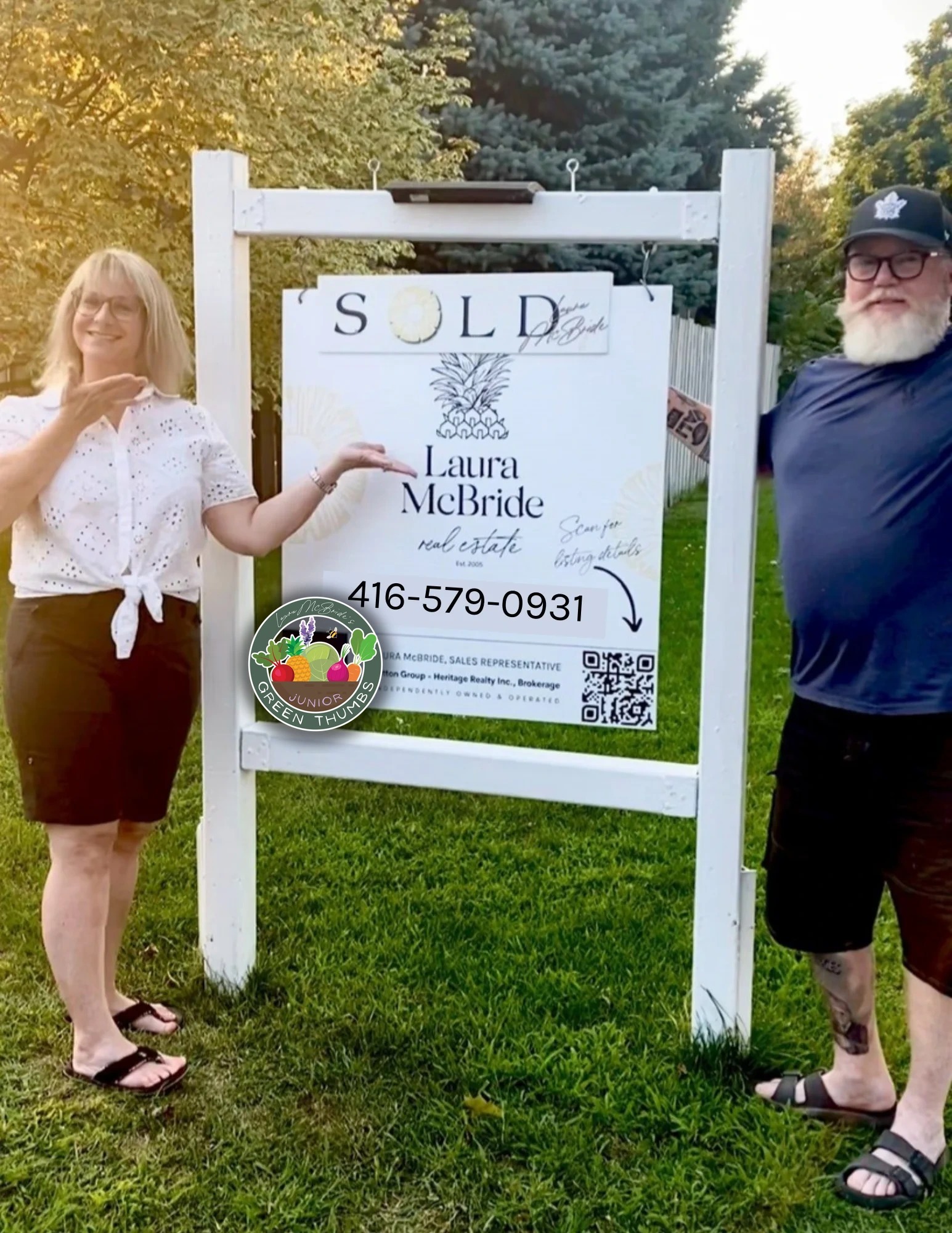 Happy sellers celebrating beside their SOLD sign with Laura McBride, Ajax REALTOR&reg;
