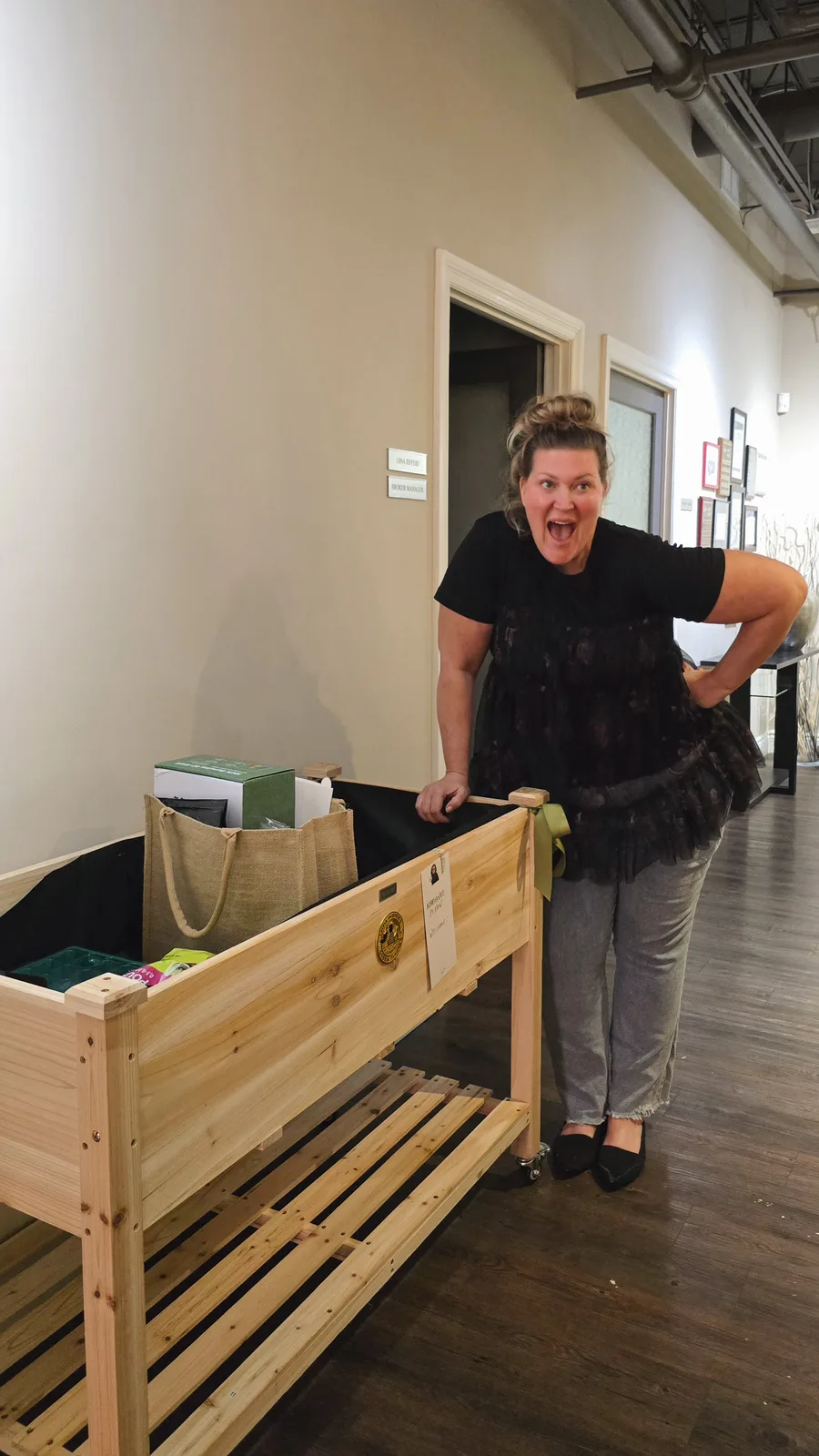 A teacher celebrates receiving her Junior Green Thumbs classroom garden from Laura McBride