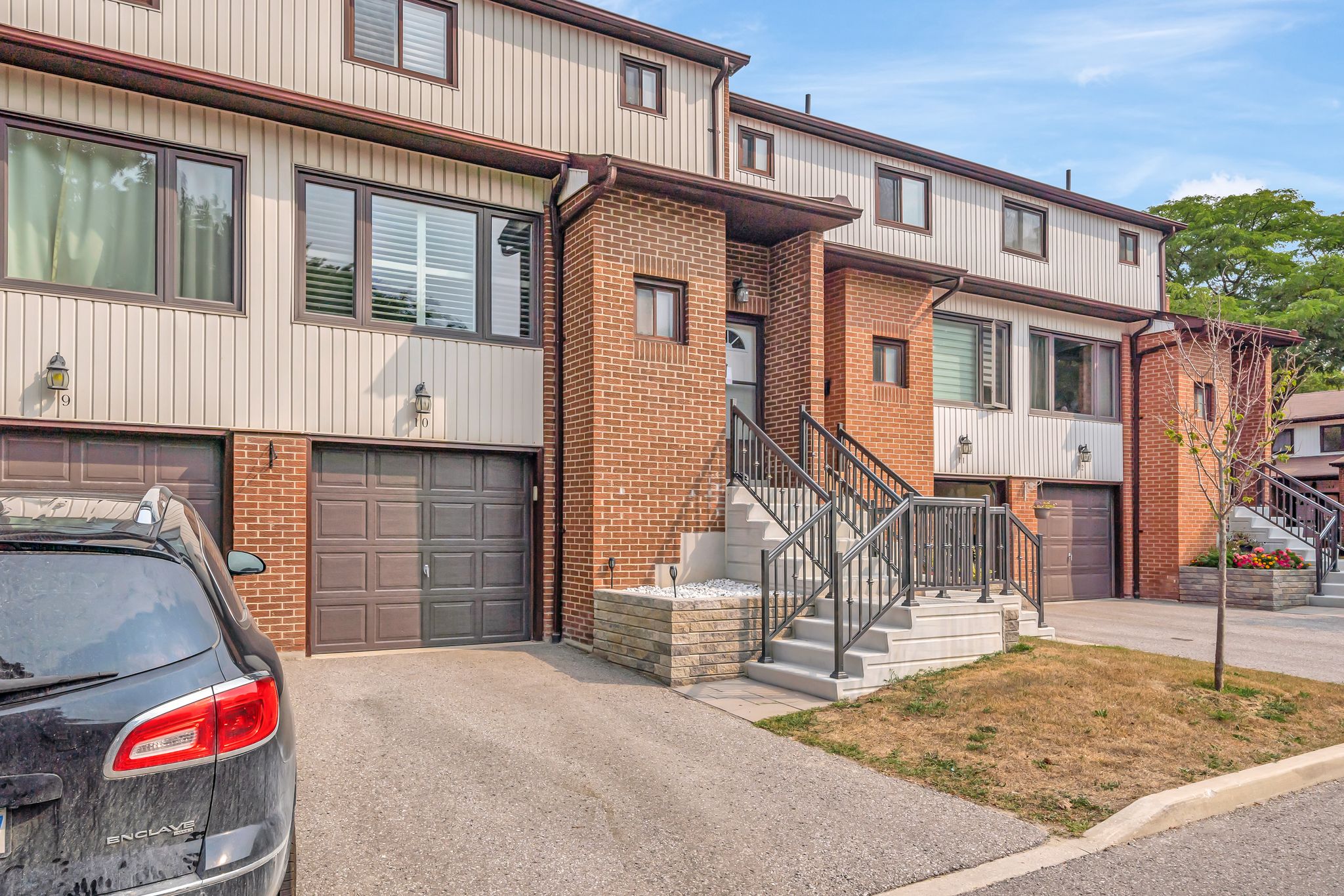 Exterior of 10-765 Oklahoma Dr, Pickering, a brick and siding condo townhouse with a built-in garage, sold by Laura McBride, Ajax REALTOR® with Revel Realty