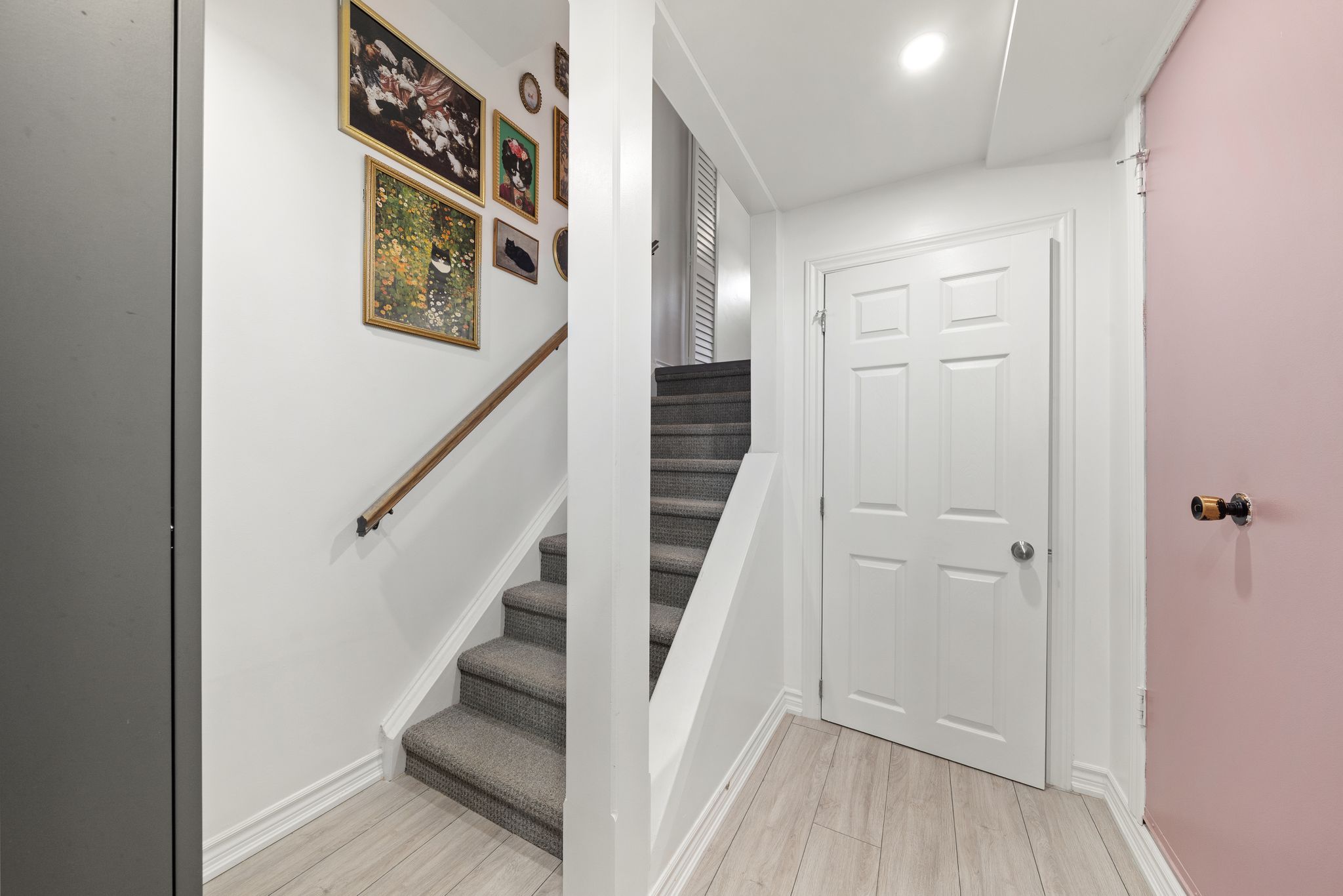 Lower-level landing at 10-765 Oklahoma Dr, Pickering, with garage access and built-in storage