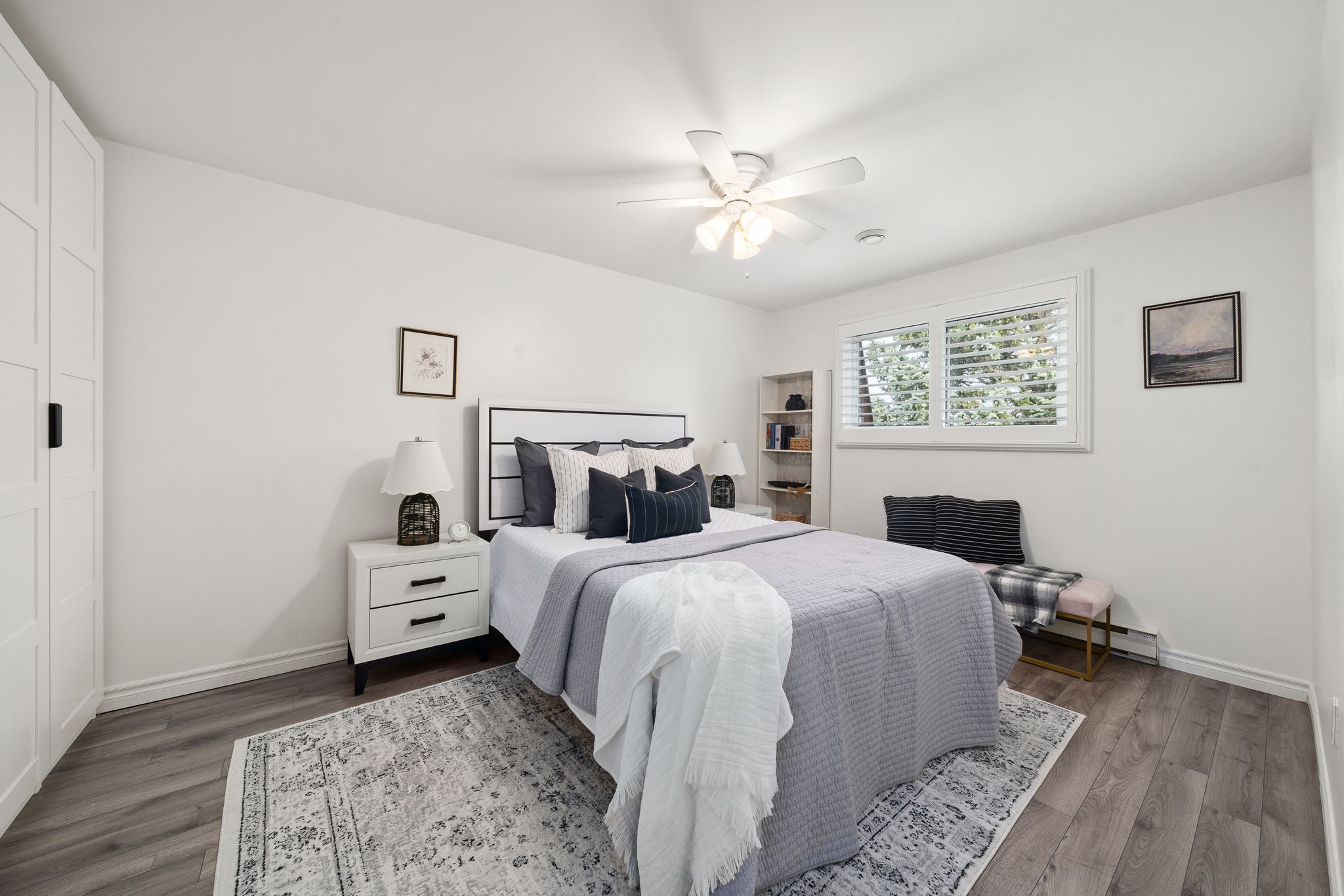 Primary bedroom at 10-765 Oklahoma Dr, Pickering, with wide plank flooring and California shutters