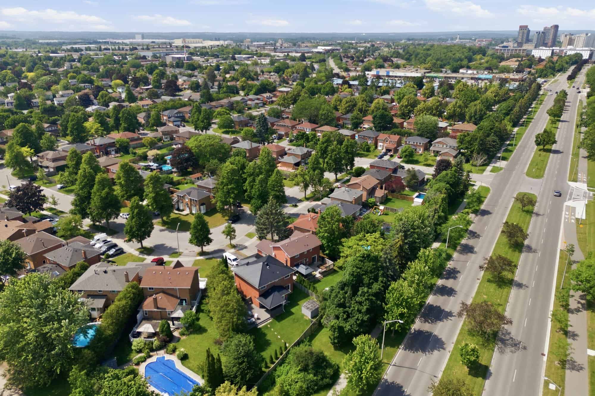 Aerial view of the Ajax neighbourhood around 13 Flowers Crescent, showing residential streets, mature trees and a nearby multi-lane road