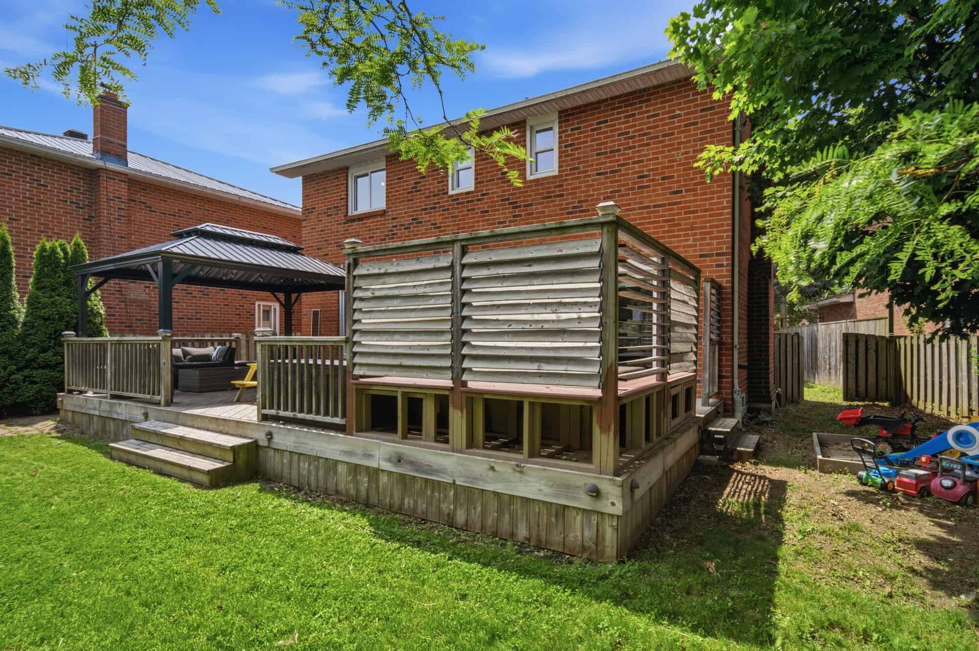 Private, fully fenced backyard at 13 Flowers Crescent, South Ajax, with mature trees and no neighbours behind