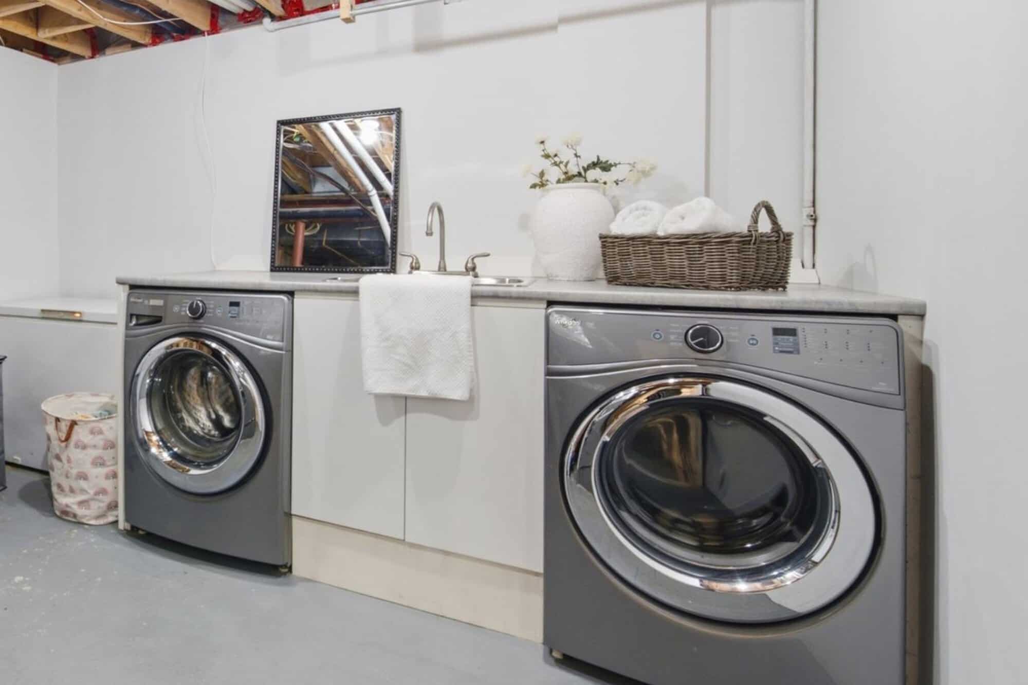 Basement laundry area at 13 Flowers Crescent, South Ajax, with a concrete floor and laundry sink