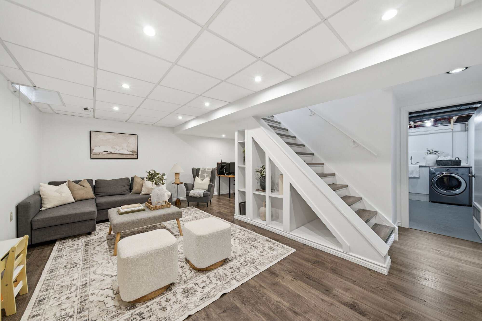 Open-concept finished basement at 13 Flowers Crescent, South Ajax, combined rec room and office space