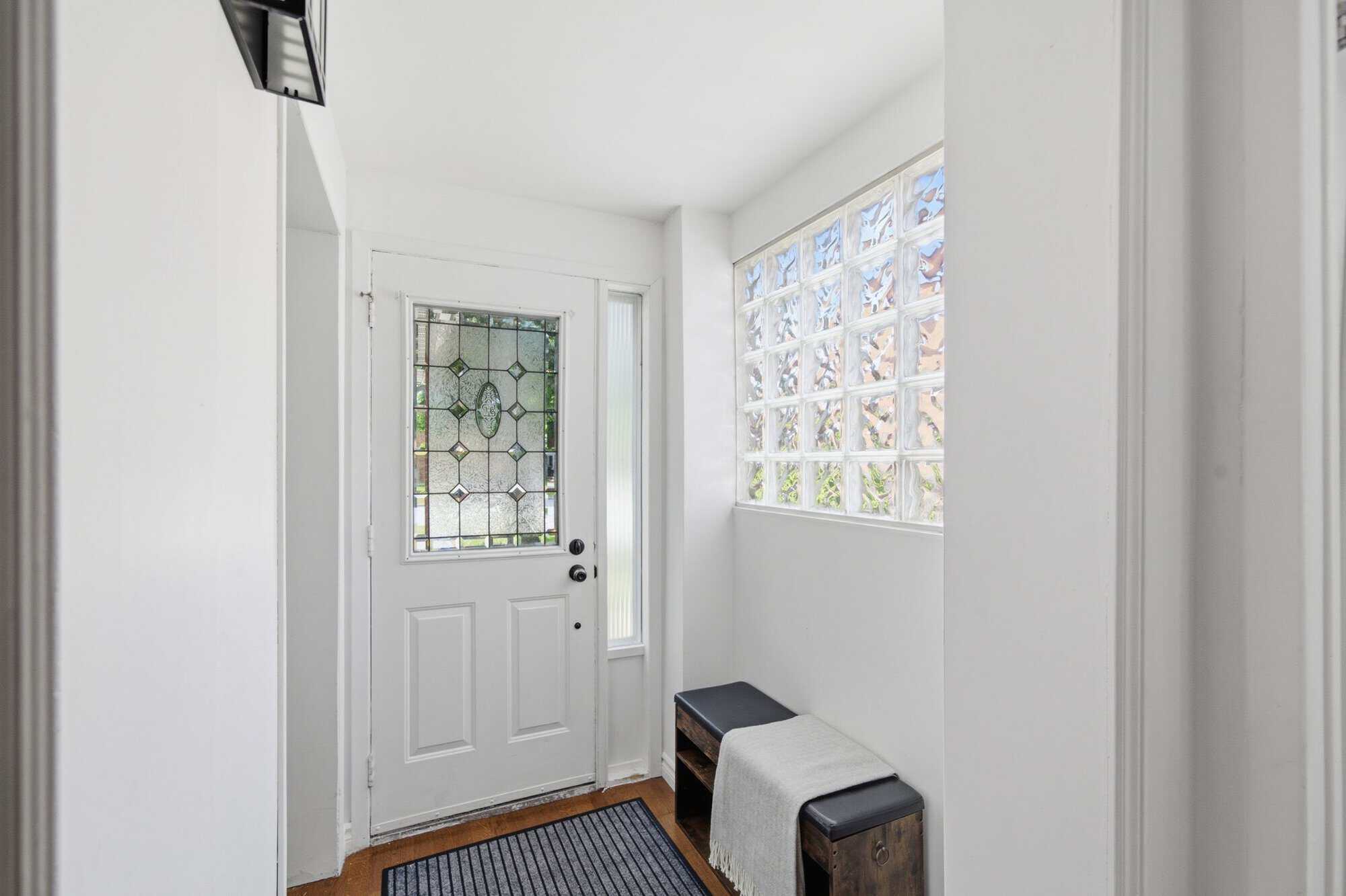 Interior hallway at 13 Flowers Crescent, South Ajax, with hardwood floors, pot lights and kitchen access