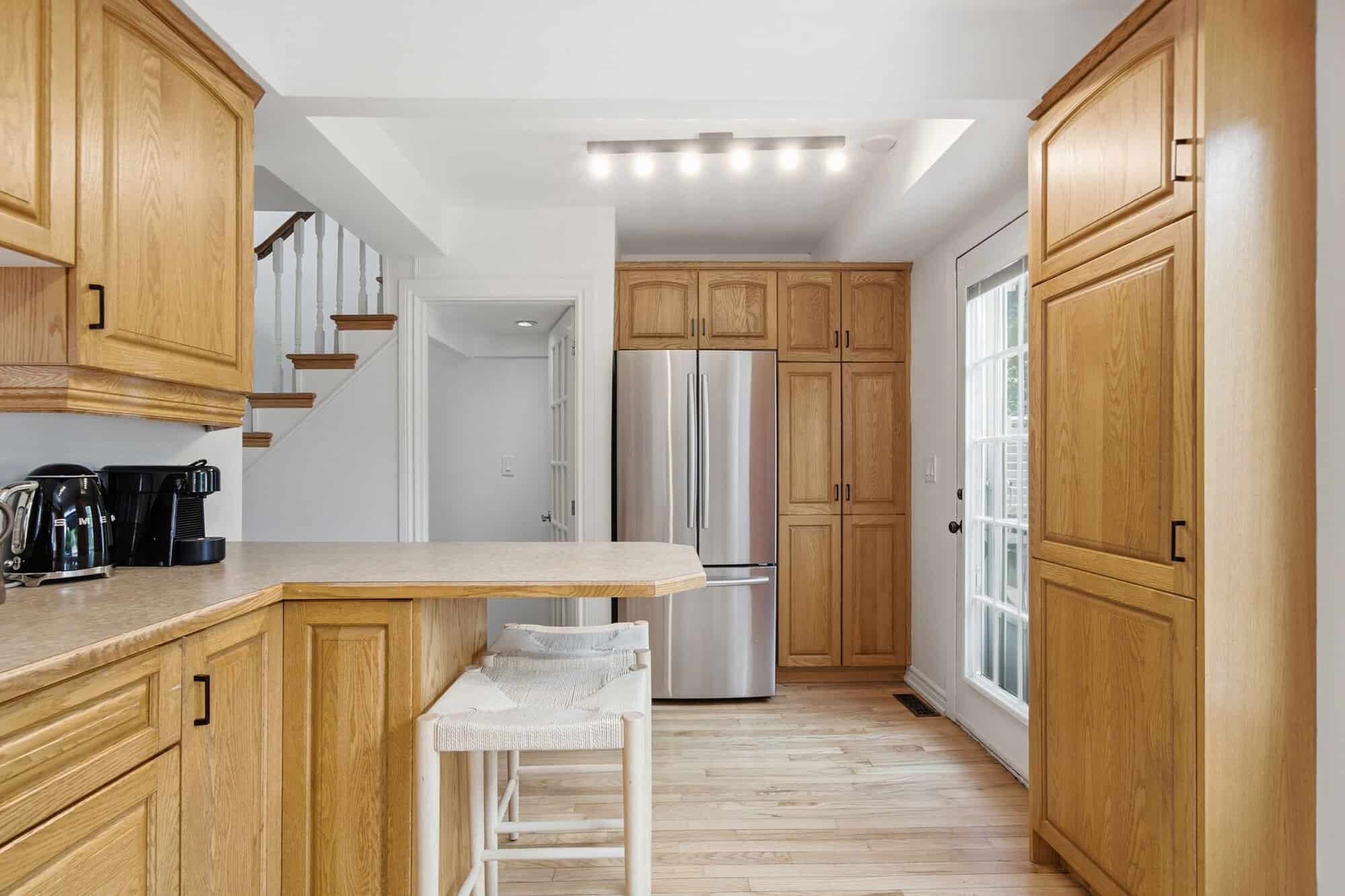 Kitchen at 13 Flowers Crescent, South Ajax, showing the stainless steel refrigerator and pantry cabinetry