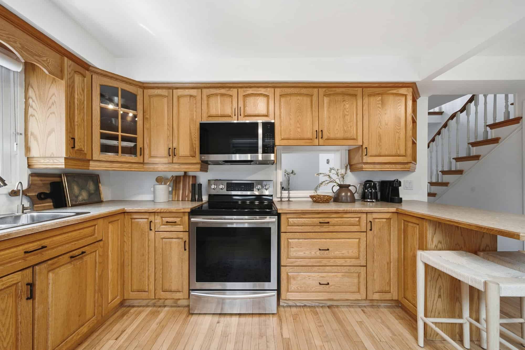 Kitchen at 13 Flowers Crescent, South Ajax, with oak cabinets, stainless steel stove and breakfast seating