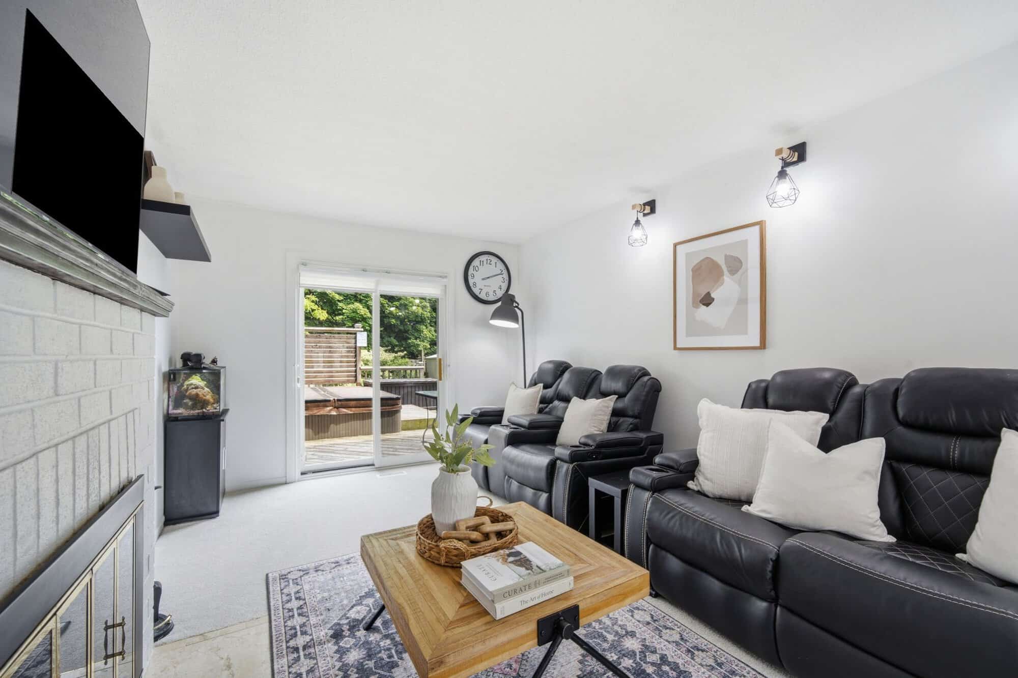 Living room at 13 Flowers Crescent, South Ajax, from a second angle showing the walk-out to the backyard deck and hot tub
