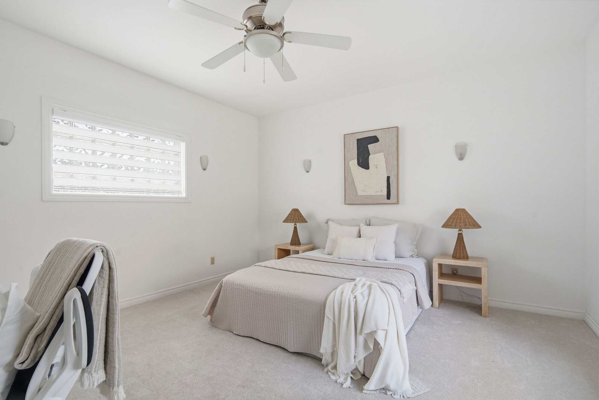 Main-floor bedroom suite at 13 Flowers Crescent, South Ajax, shown from a second angle with two wood nightstands and a ceiling fan