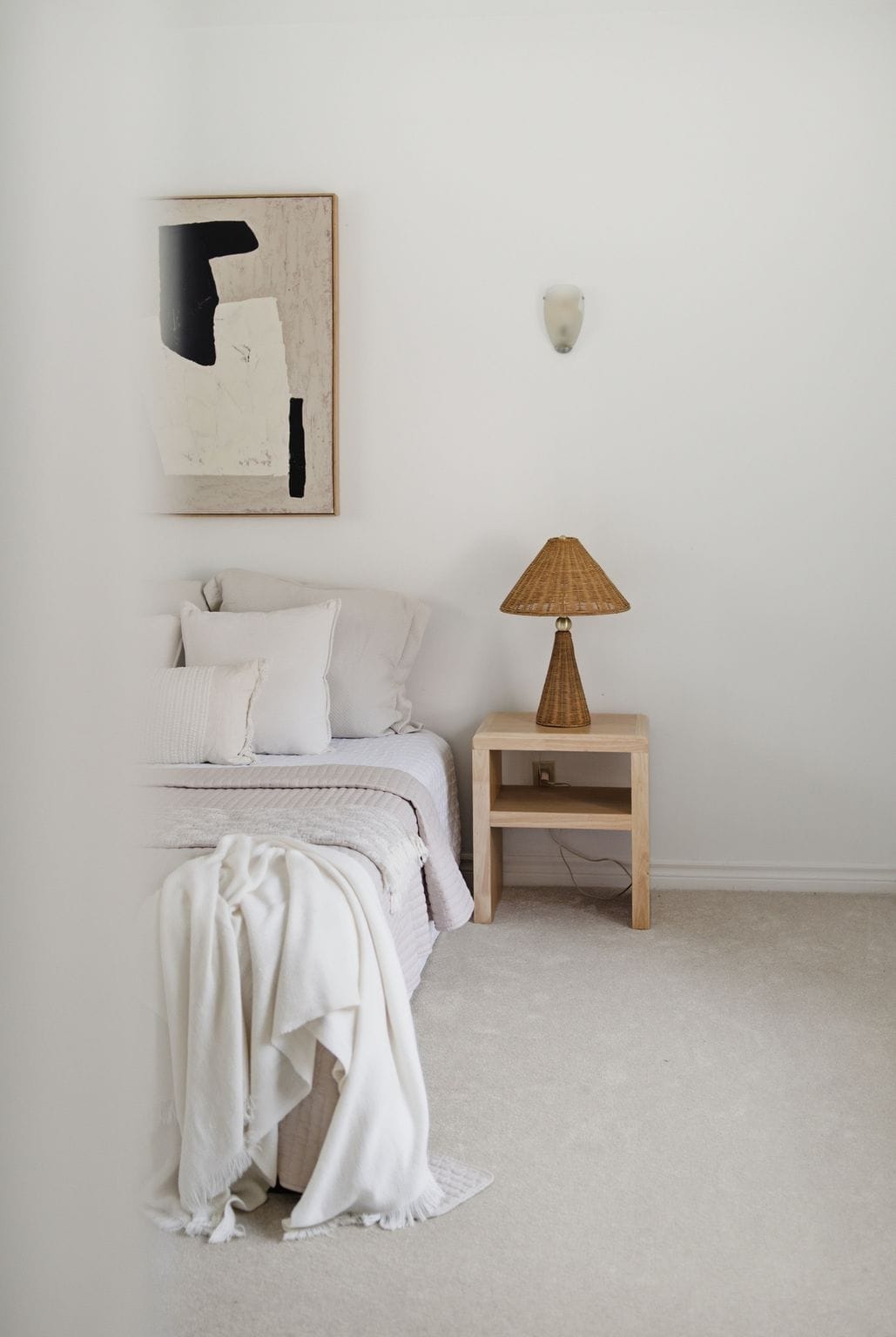 Main-floor bedroom suite at 13 Flowers Crescent, South Ajax, in the converted garage, with neutral bedding and a wood nightstand