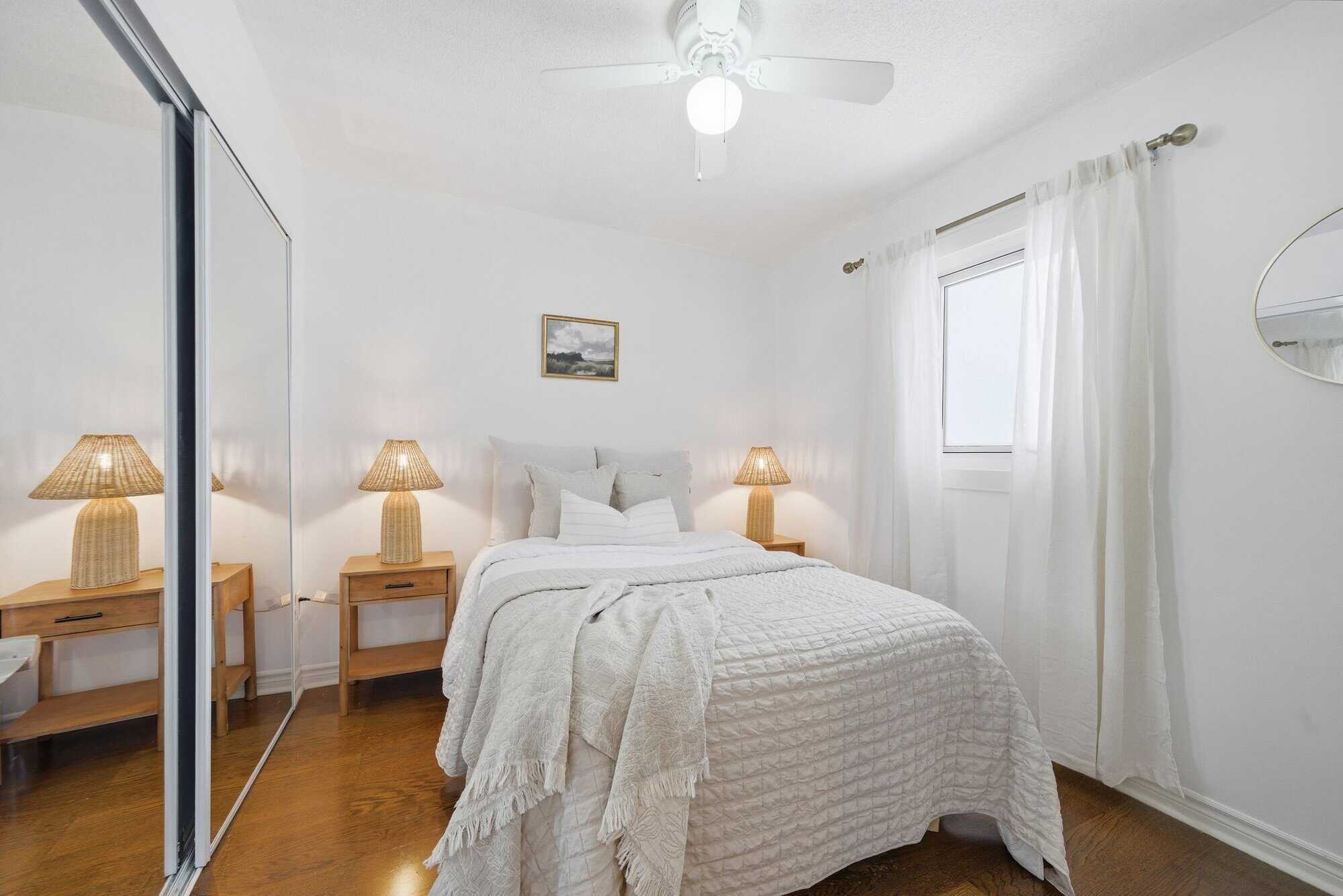 Second bedroom at 13 Rollo Drive, South East Ajax, with built-in shelves and hardwood floors