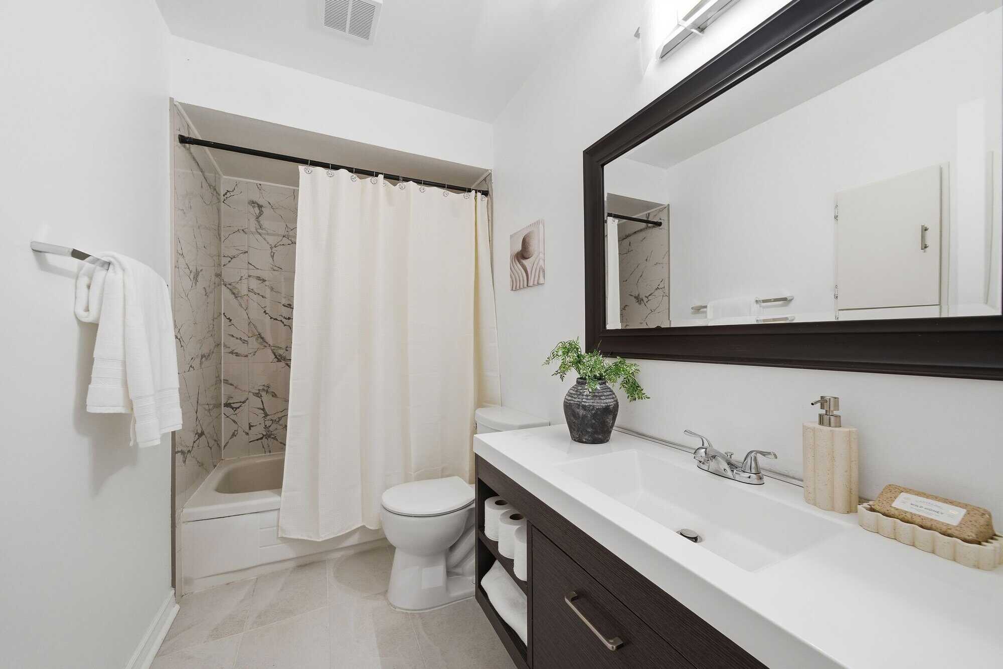 Main bathroom detail at 13 Rollo Drive, South East Ajax, with warm tile flooring