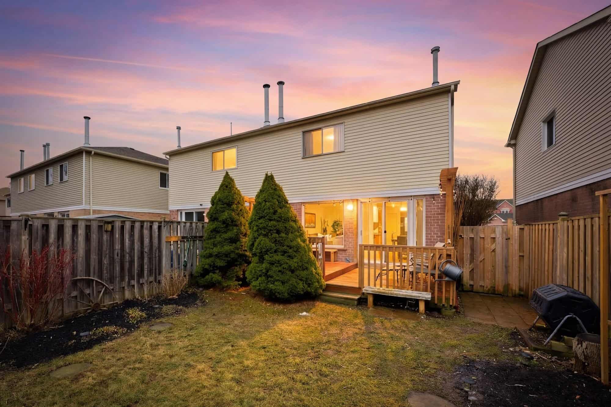 Rear exterior of 13 Rollo Drive, South East Ajax, at twilight