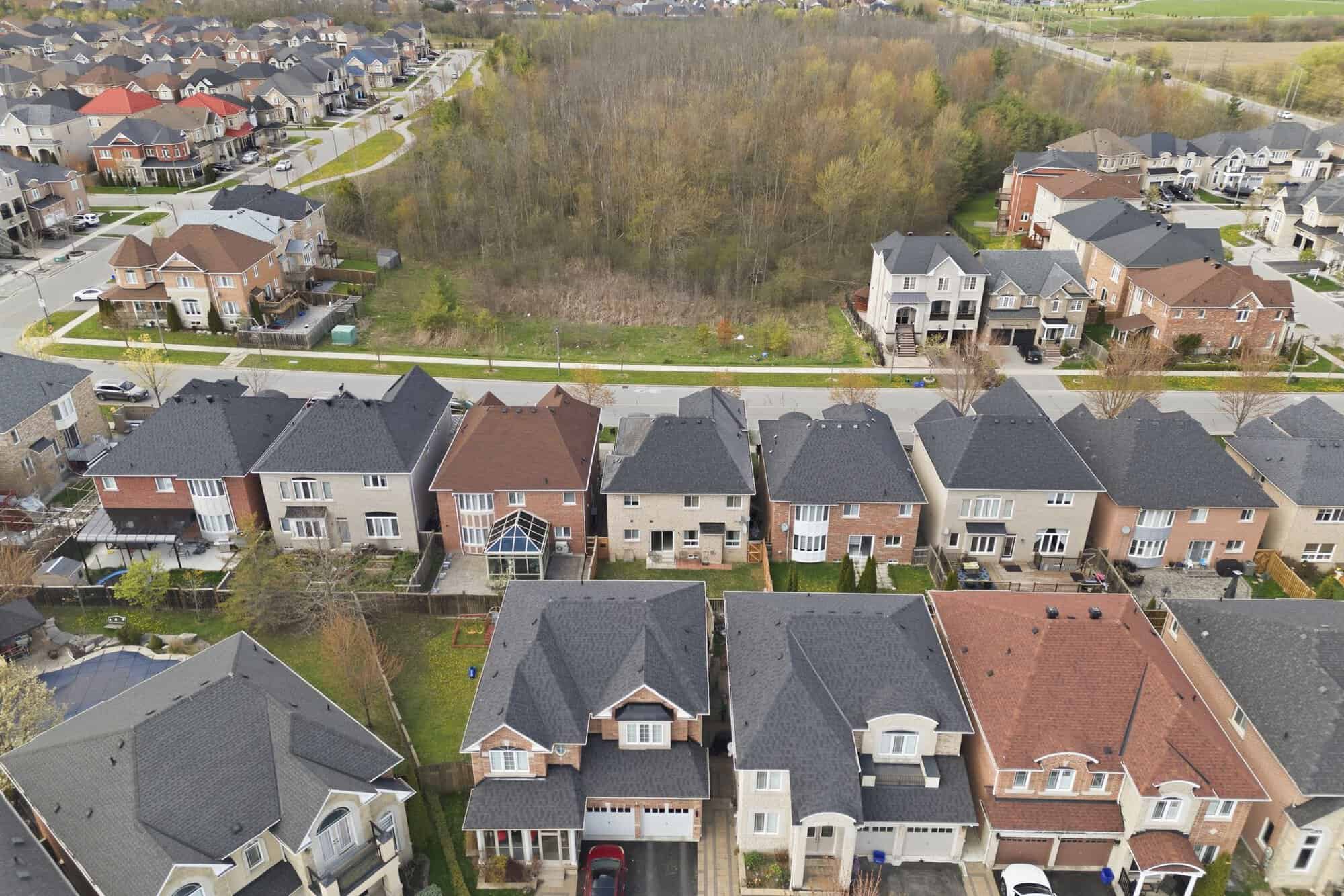 Closer aerial view of homes in the Castlefields neighbourhood, North East Ajax, backing onto woodland