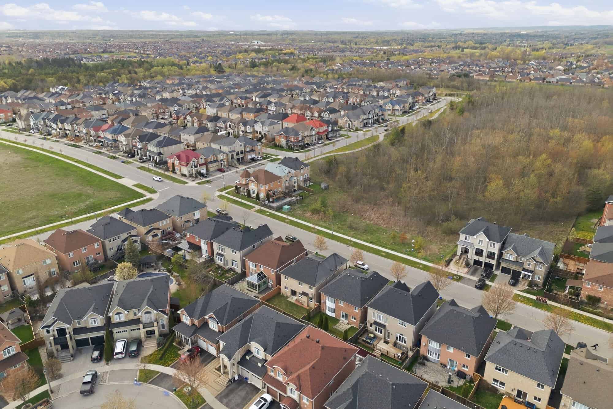 Aerial view of the Castlefields neighbourhood in North East Ajax, showing homes bordered by woodland and greenspace