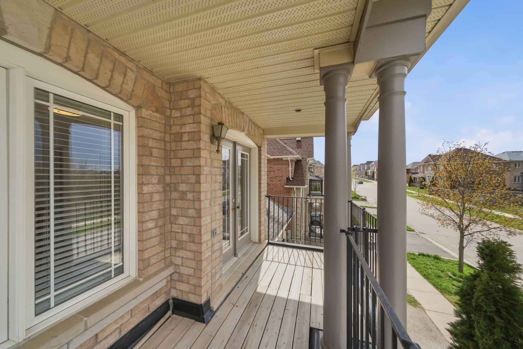 Upper covered balcony at 131 Rushworth Drive, Ajax, overlooking the woodland across the street