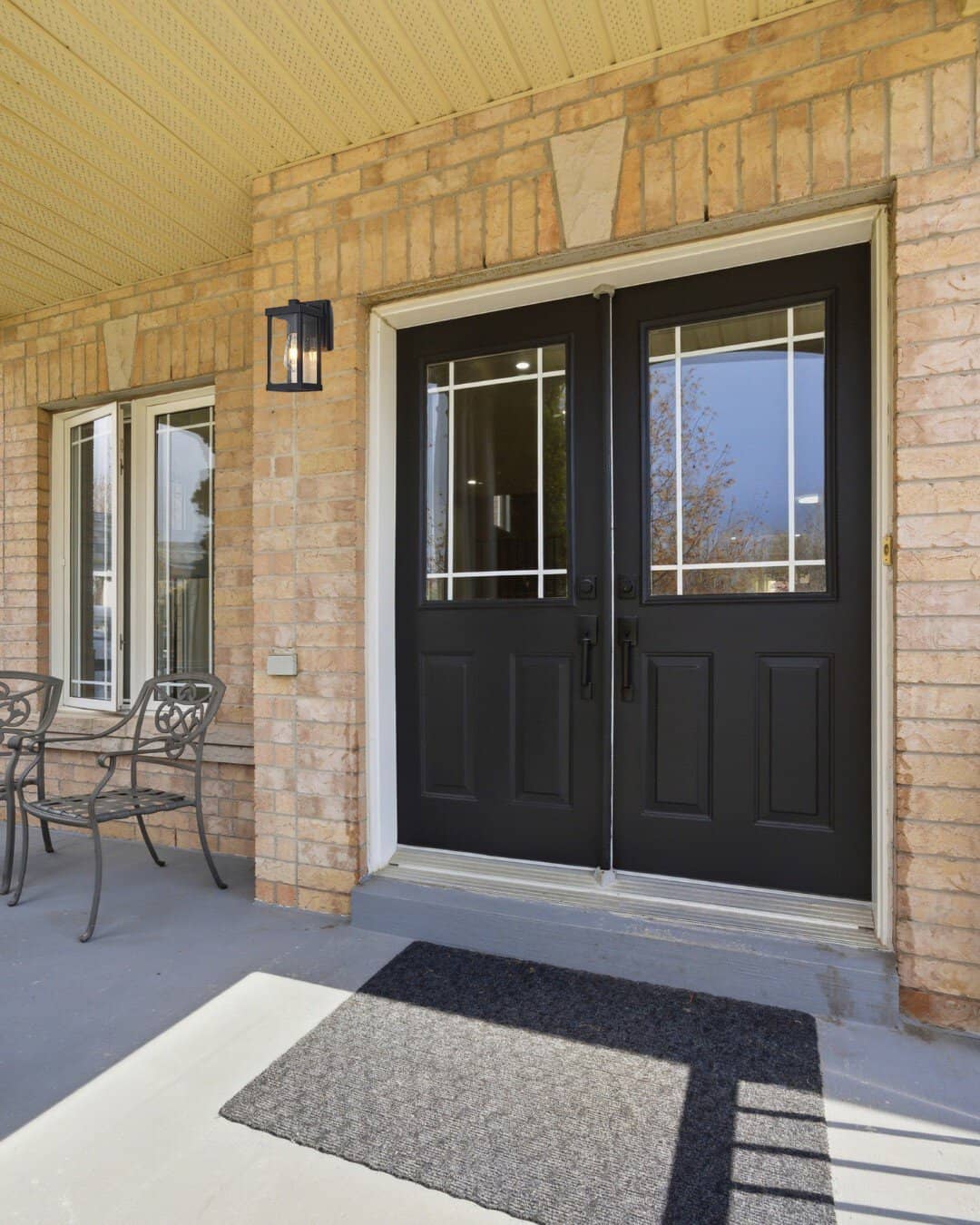 Covered front porch at 131 Rushworth Drive, Ajax, overlooking the street and woodland beyond