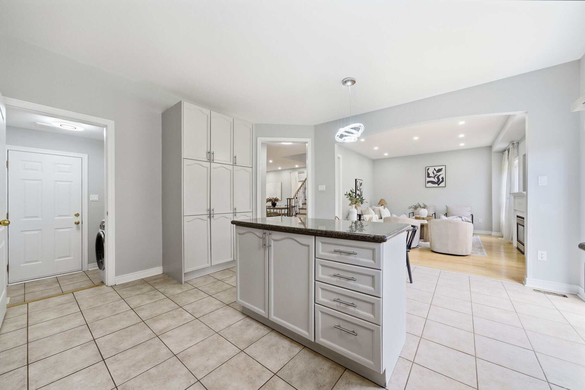 Kitchen island at 131 Rushworth Drive, Ajax, with a view into the family room beyond