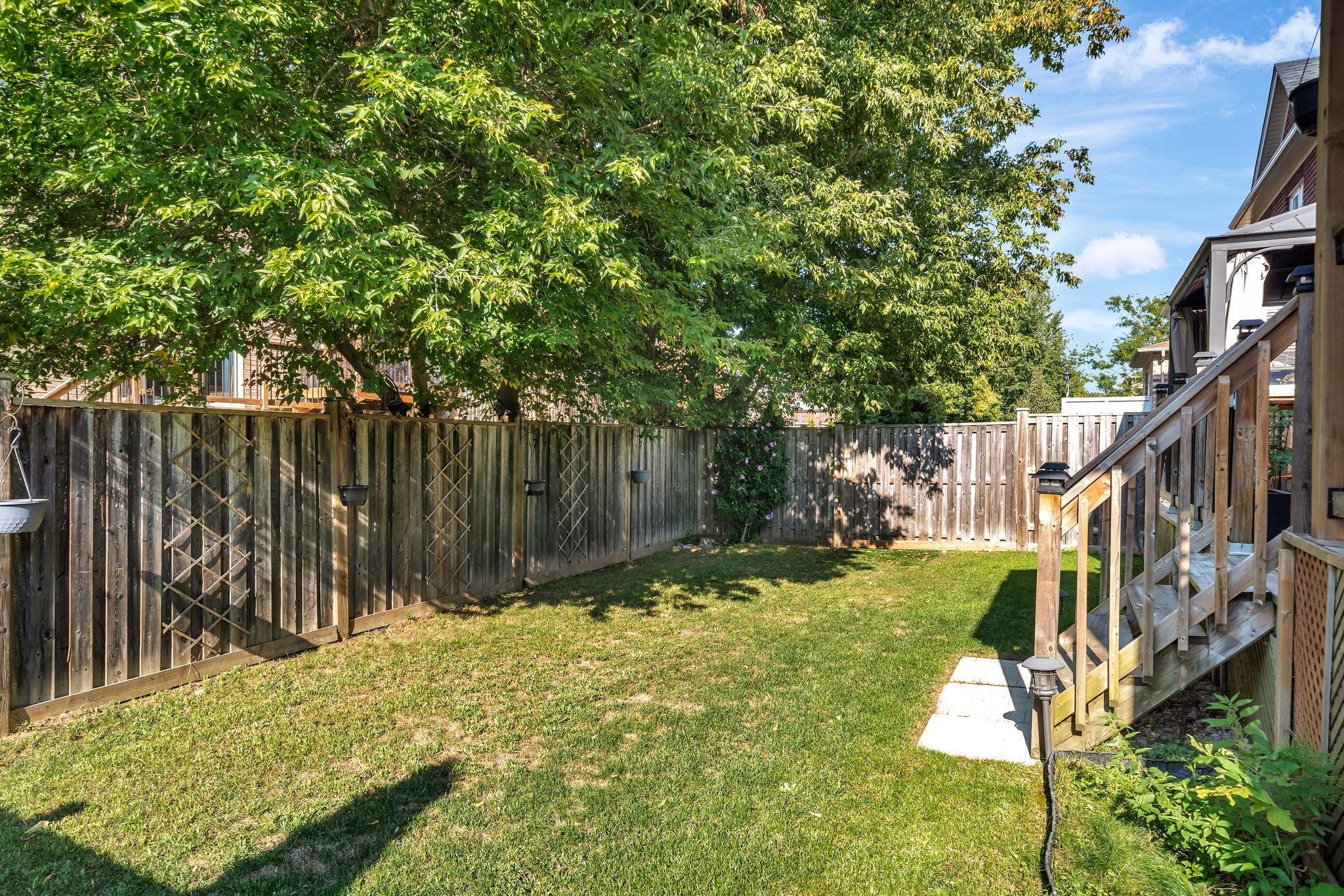 Fenced backyard at 14 Sleepy Hollow Place, Whitby, with mature trees
