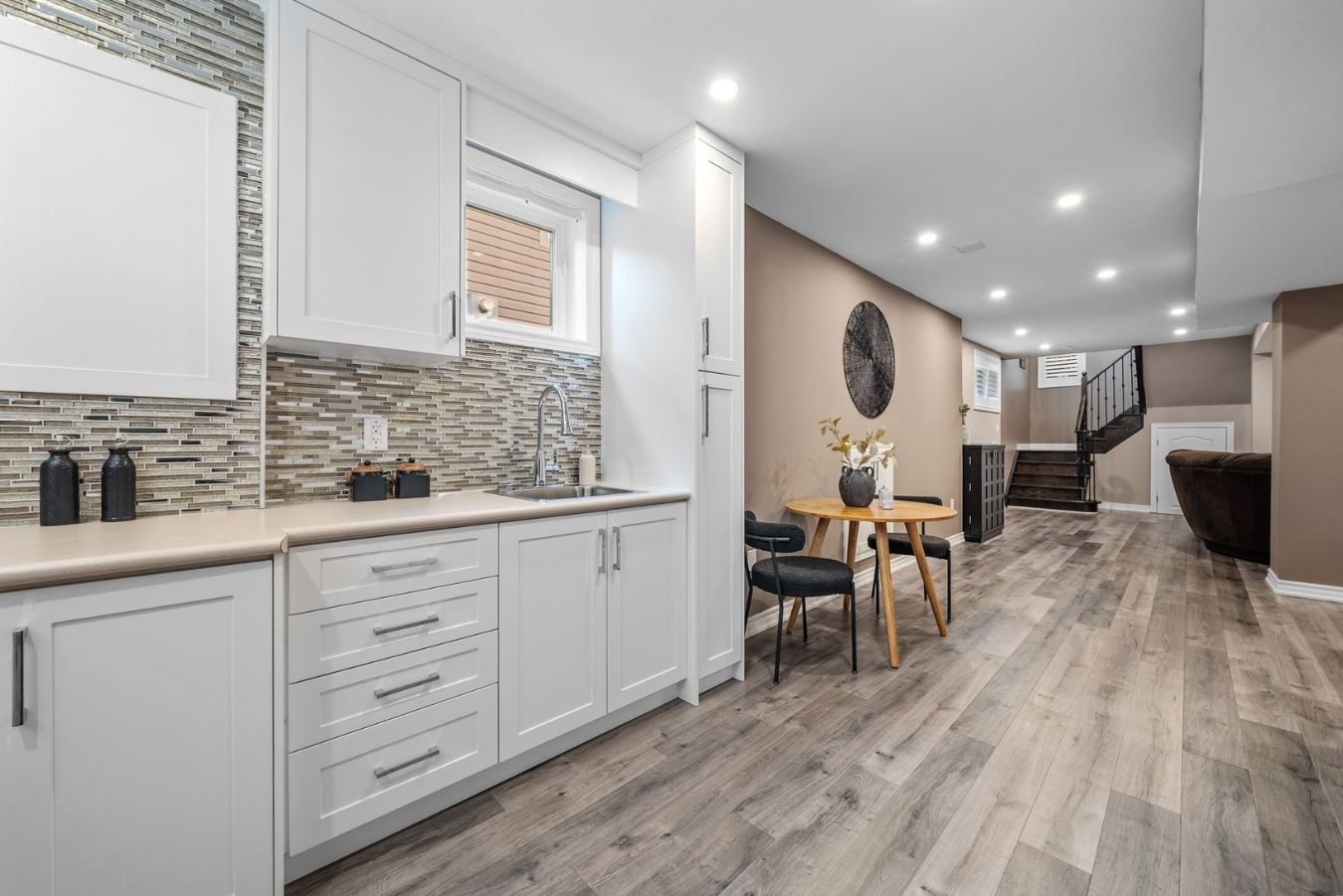 Basement kitchenette at 14 Sleepy Hollow Place, Whitby, with cabinetry and an adjoining dining nook