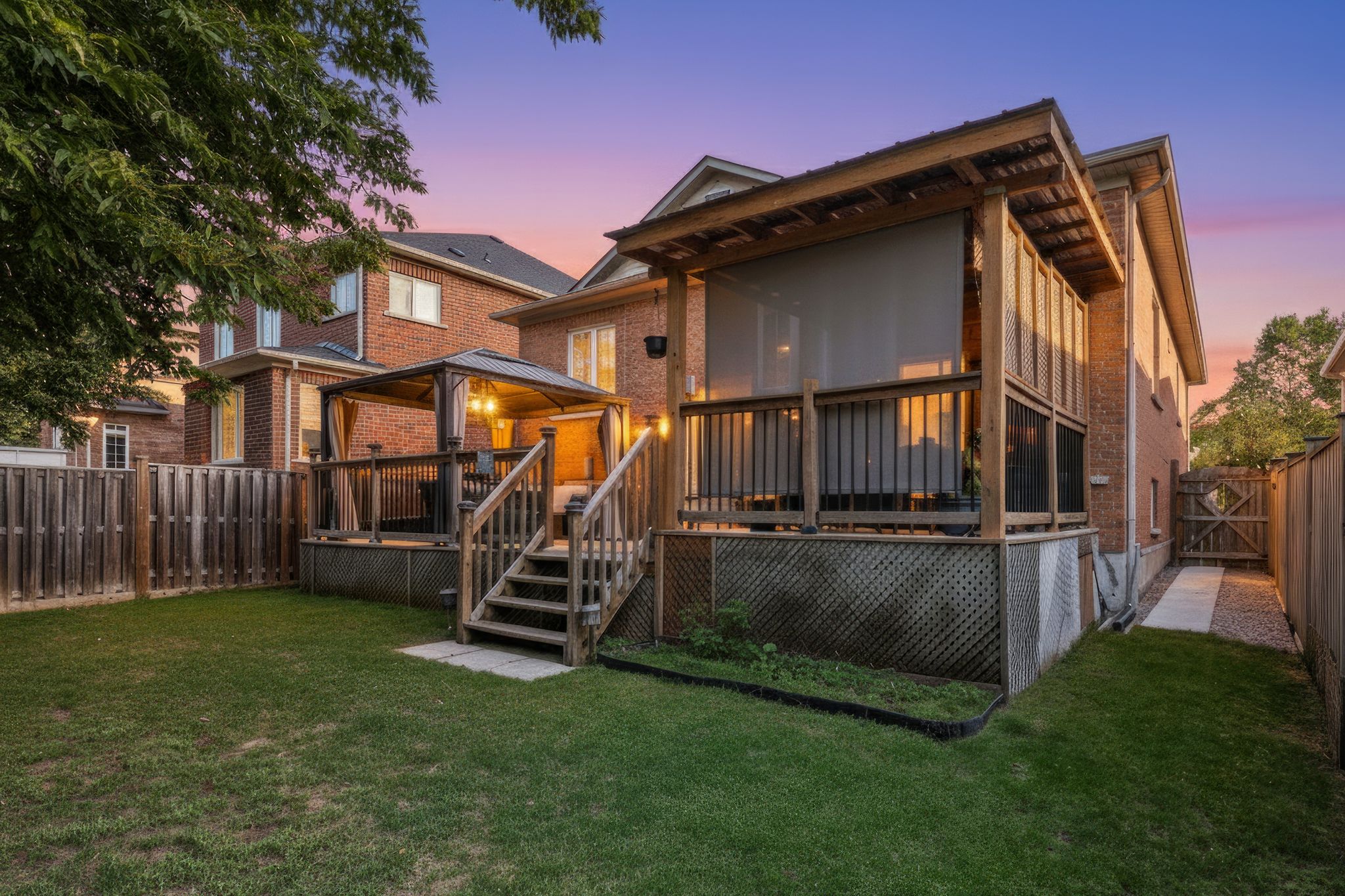 Rear exterior of 14 Sleepy Hollow Place, Whitby, at sunset, with a covered deck