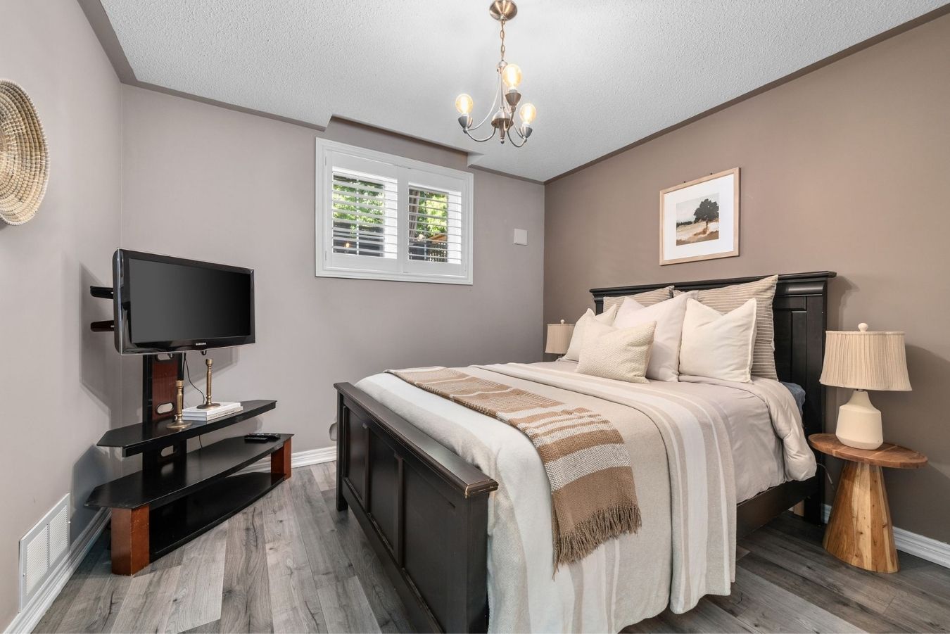Third bedroom in the finished basement at 14 Sleepy Hollow Place, Whitby, with a television and dresser