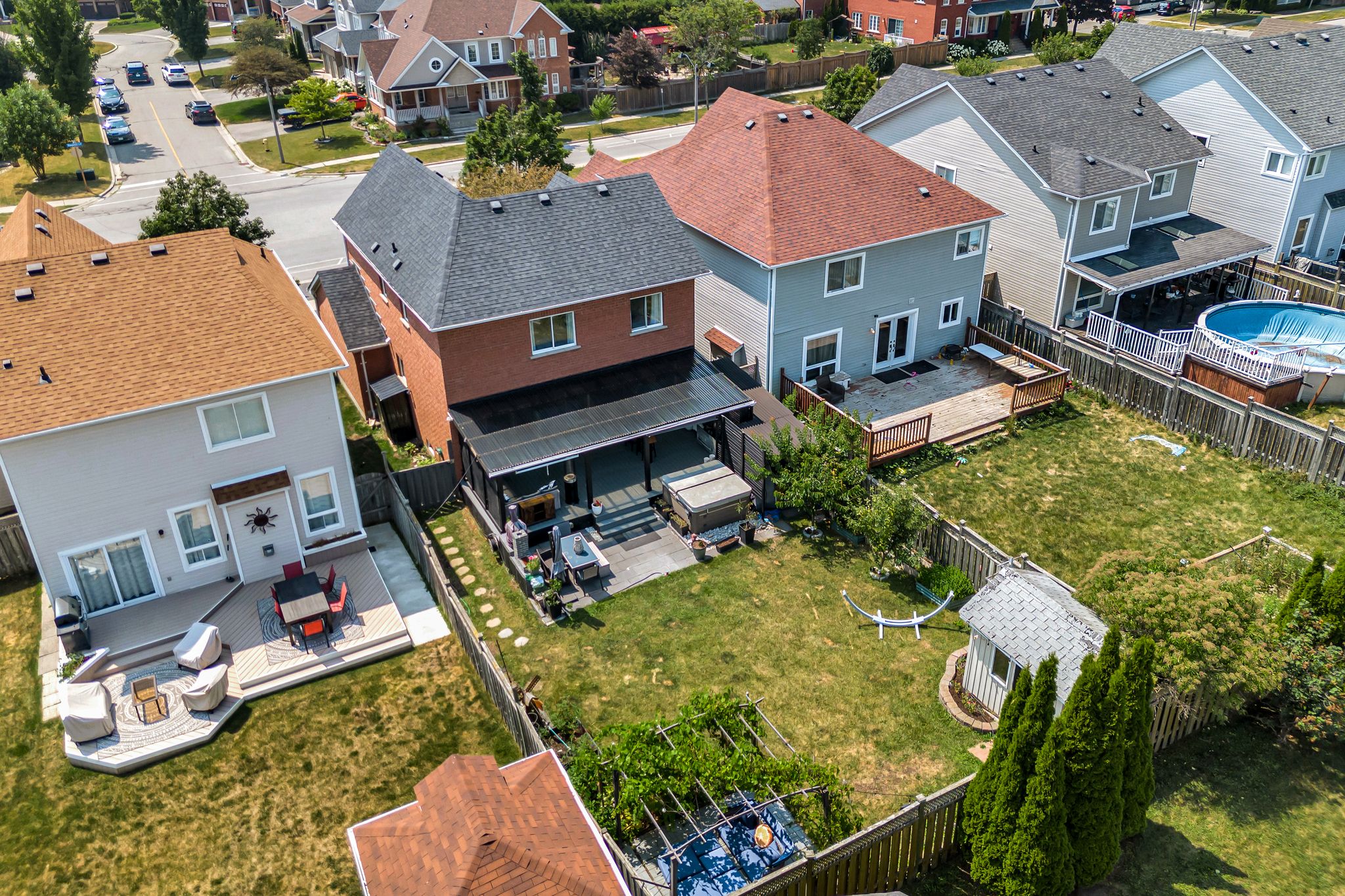 Aerial backyard view of 1509 Grandview Street North, Oshawa, showing the covered deck, fenced yard and surrounding North Oshawa neighbourhood