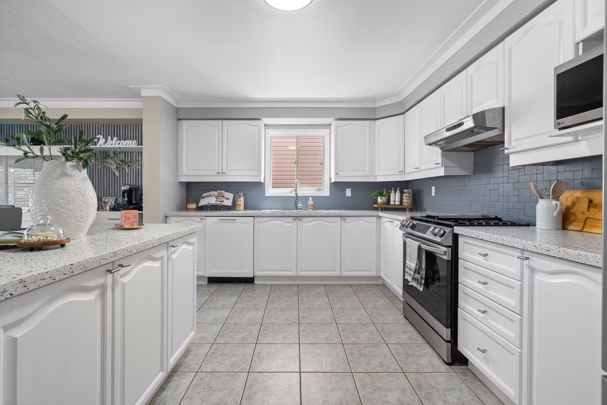 Kitchen at 1509 Grandview Street North, Oshawa, with white cabinetry, quartz counters and stainless steel appliances