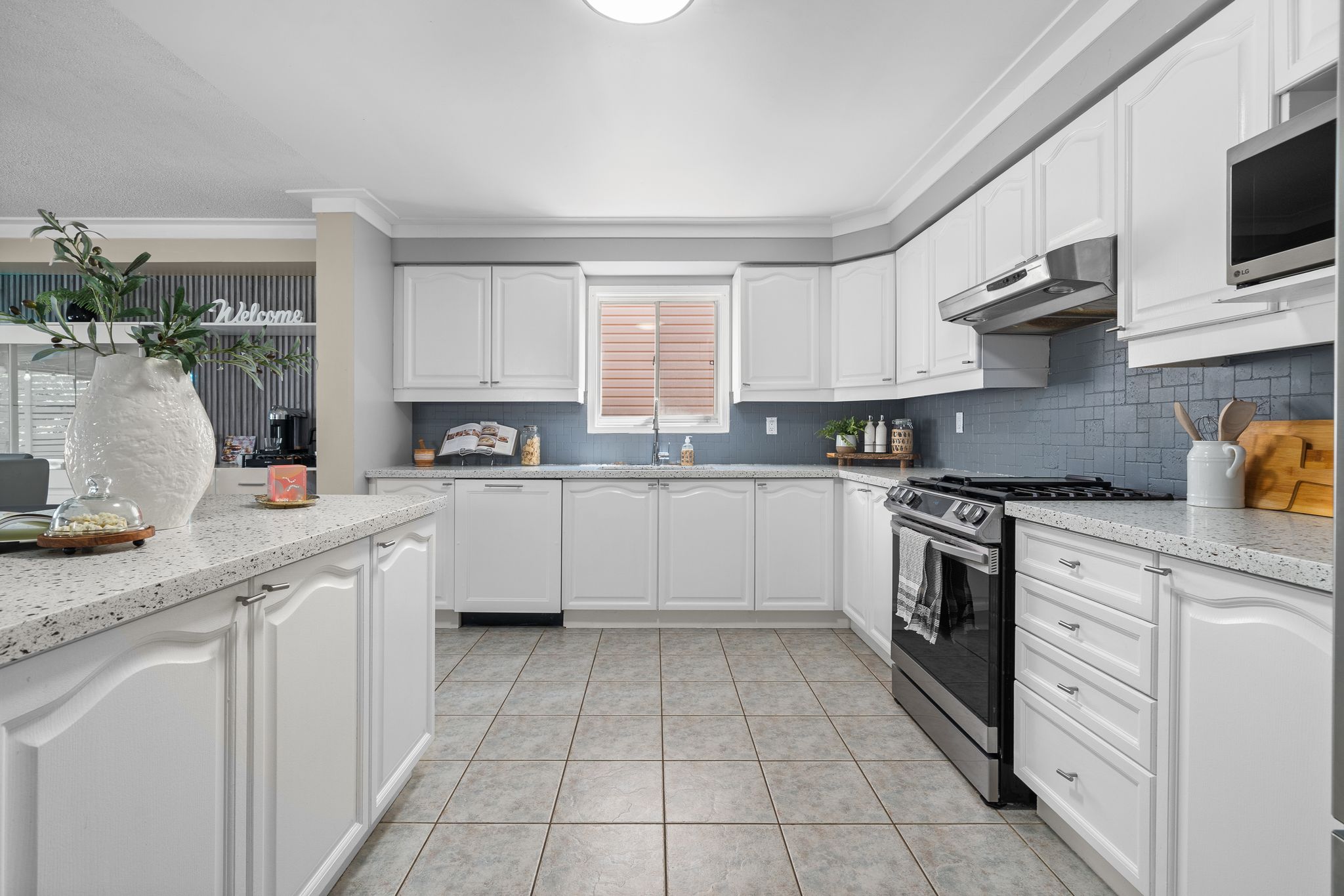 Kitchen at 1509 Grandview Street North, Oshawa, with white cabinetry, quartz counters and stainless steel appliances