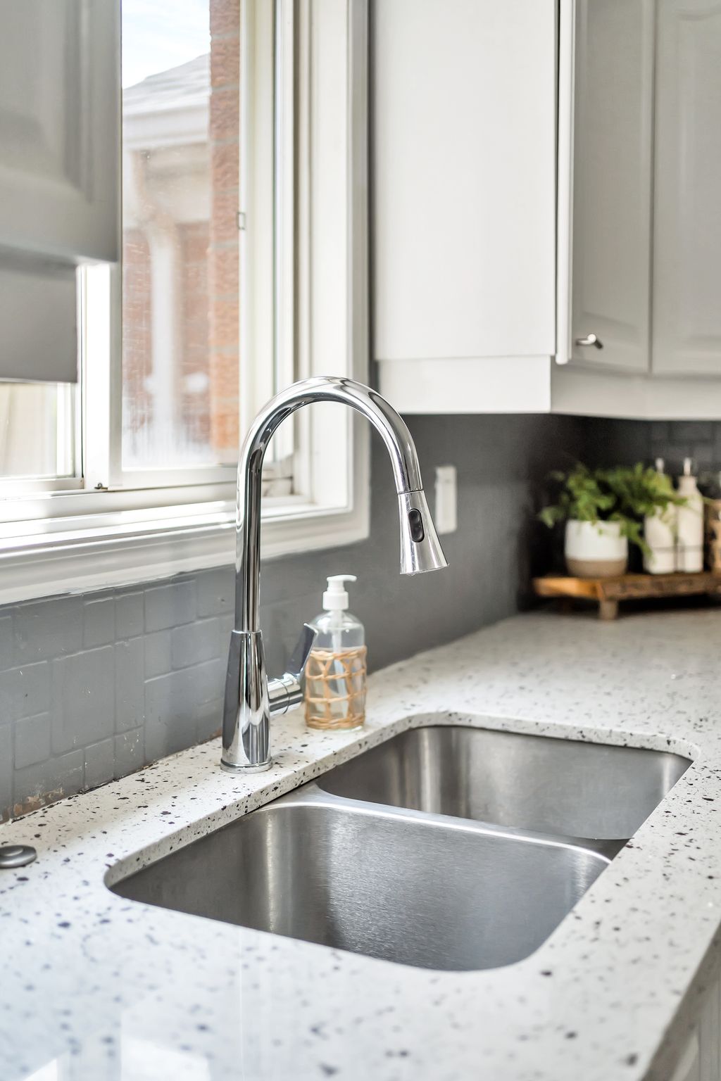 Kitchen sink and faucet detail at 1509 Grandview Street North, Oshawa, with quartz counters