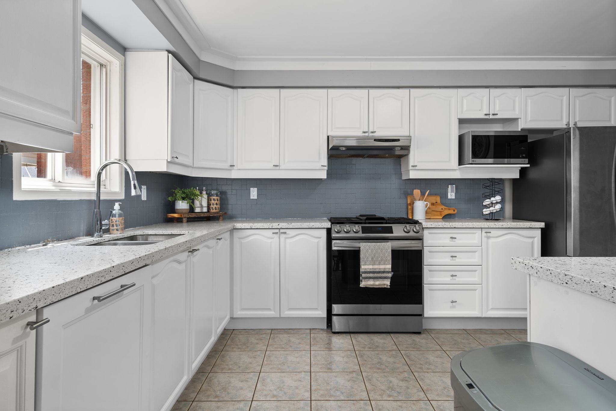 Kitchen at 1509 Grandview Street North, Oshawa, with a gas stove and white cabinetry