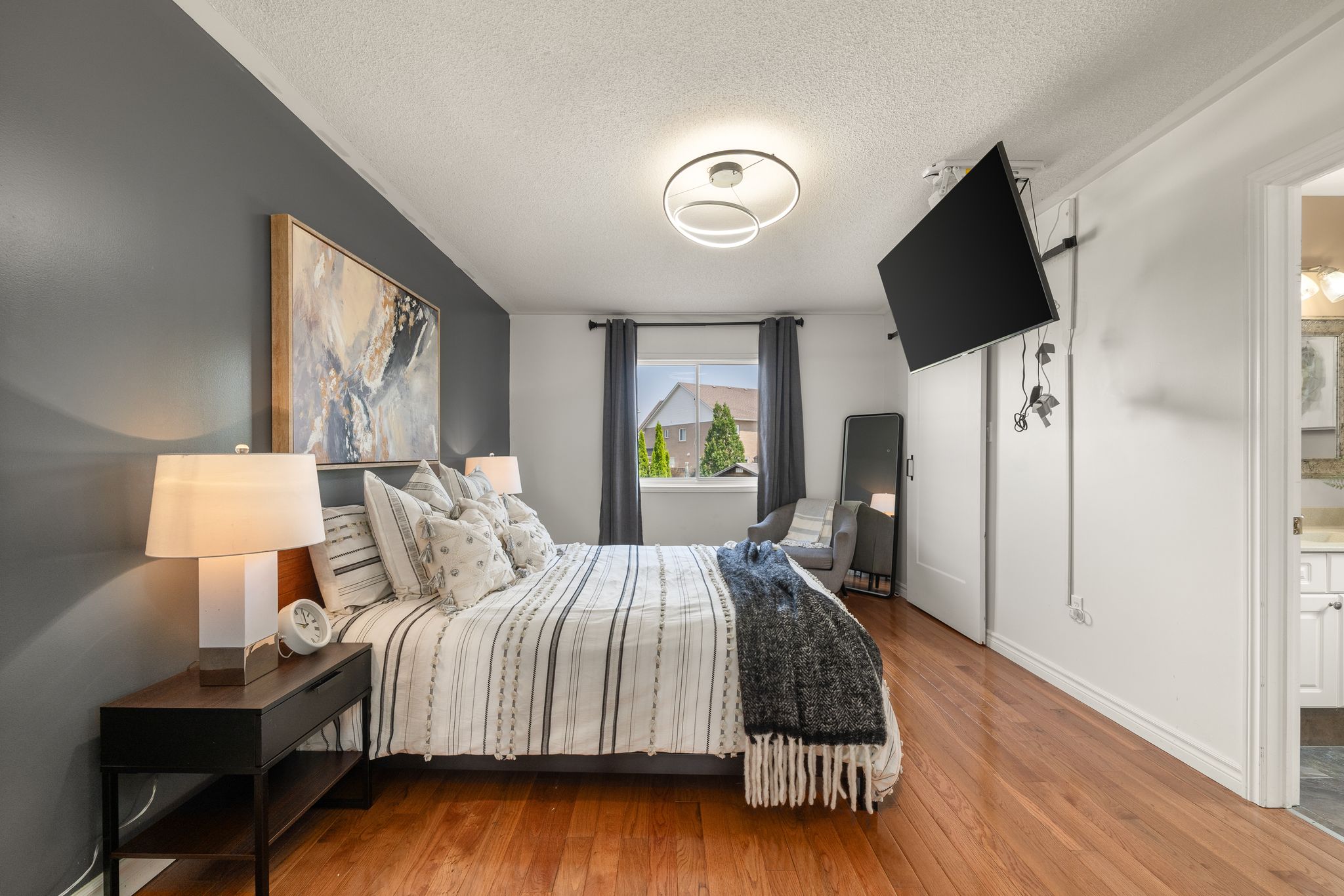 Primary bedroom at 1509 Grandview Street North, Oshawa, with hardwood floors and neutral tones