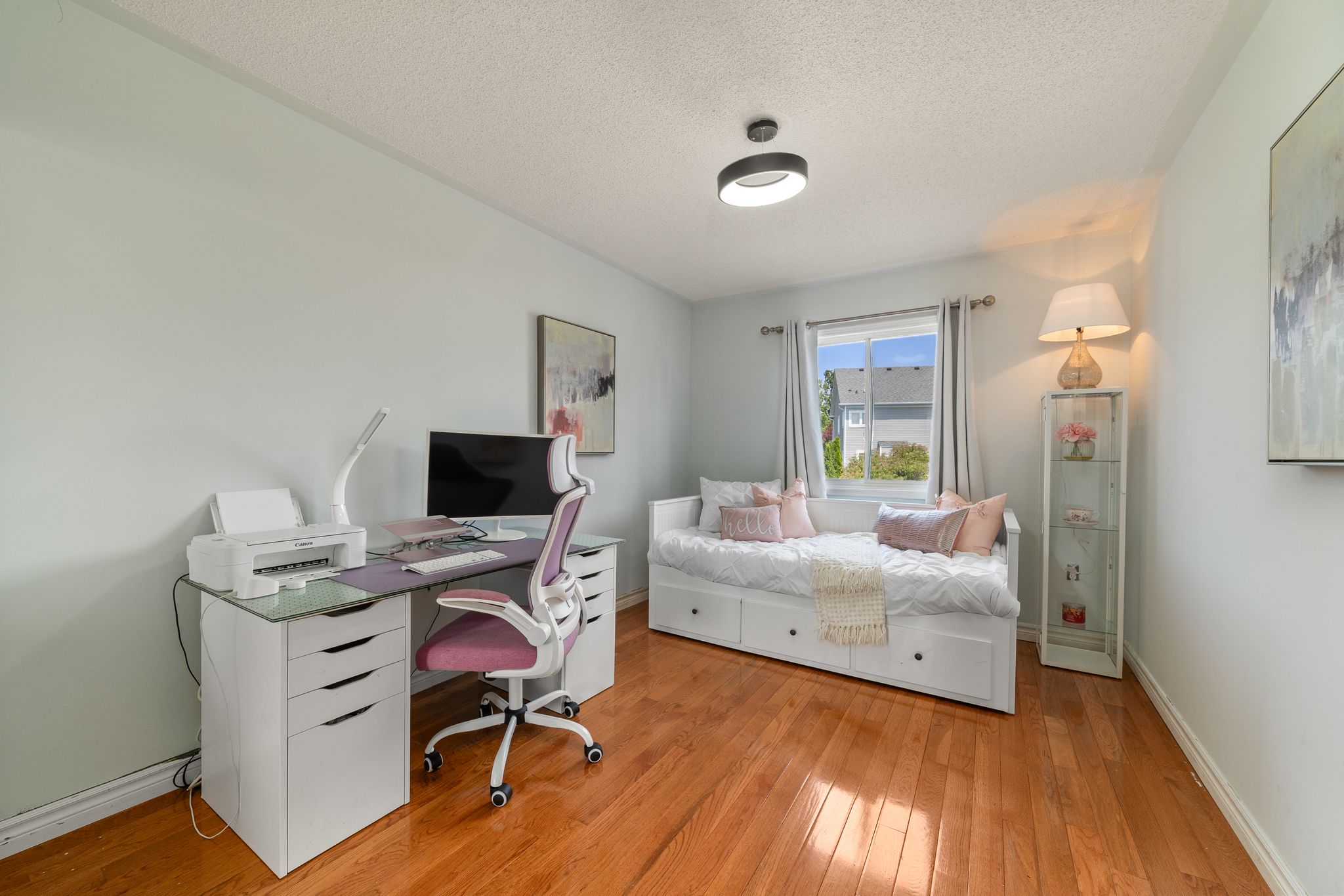 Third bedroom at 1509 Grandview Street North, Oshawa, with hardwood floors and a mounted television