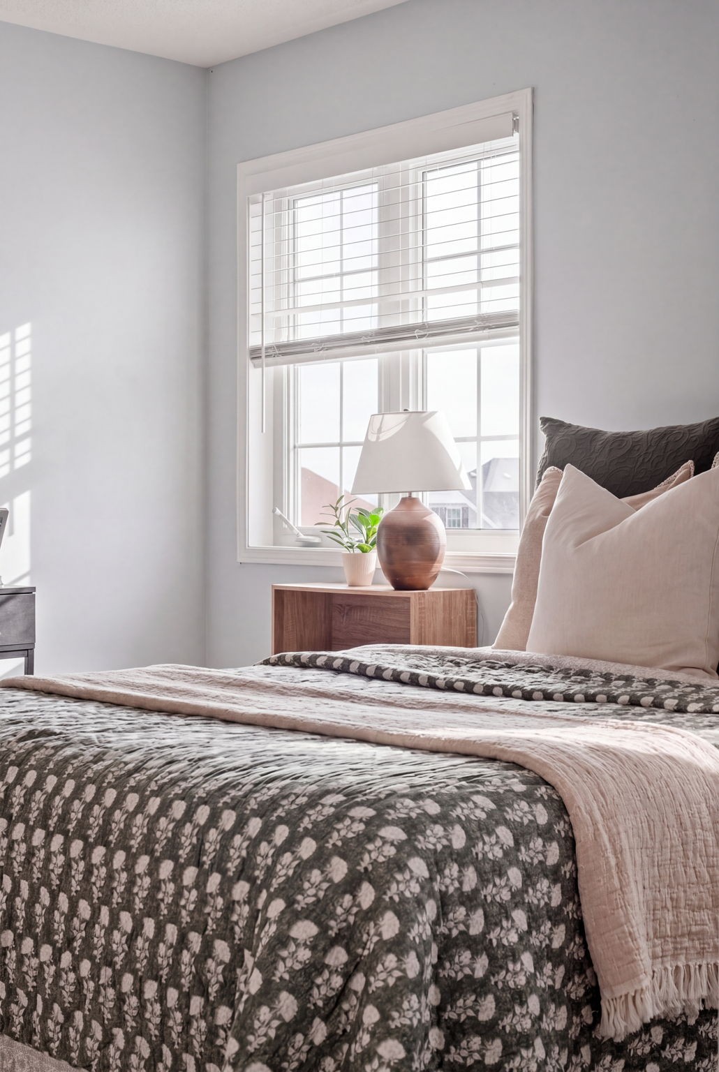 Fourth bedroom at 1683 Finkle Drive, Oshawa, with a floral quilt and copper table lamp by the window