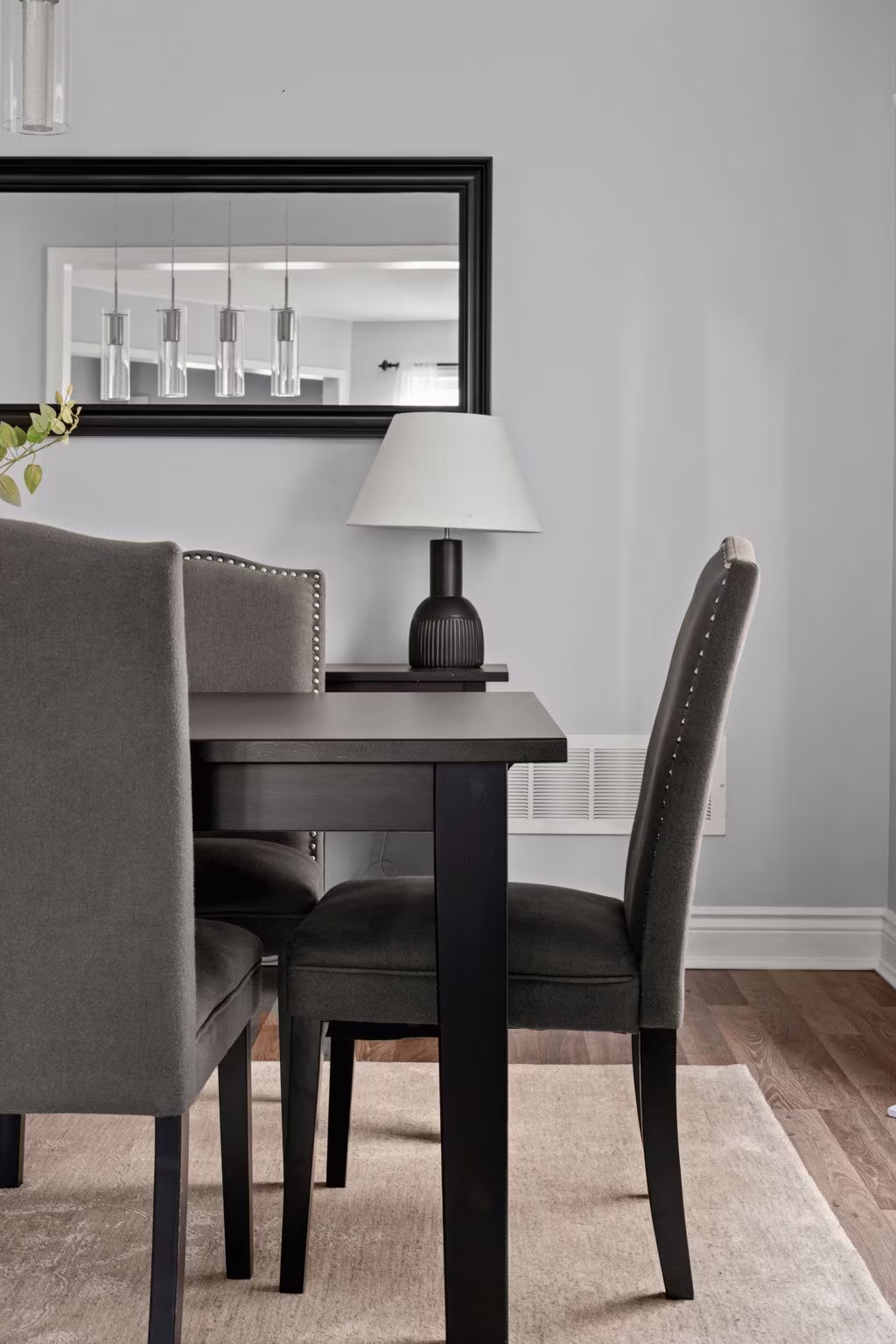 Dining room styling detail at 1683 Finkle Drive, Oshawa, with upholstered chairs and a framed mirror