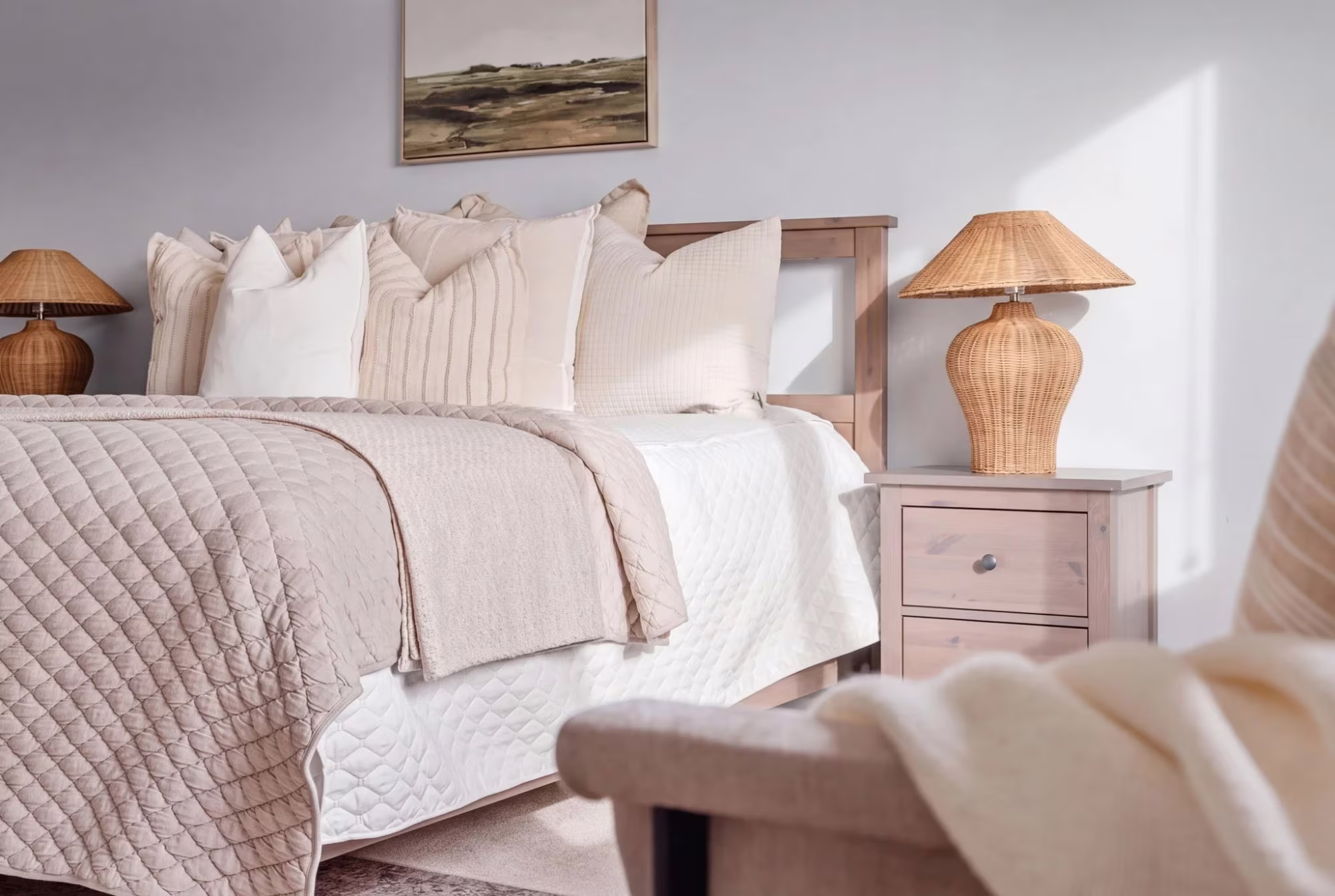 Primary bedroom styling detail at 1683 Finkle Drive, Oshawa, with layered neutral bedding and a woven lamp