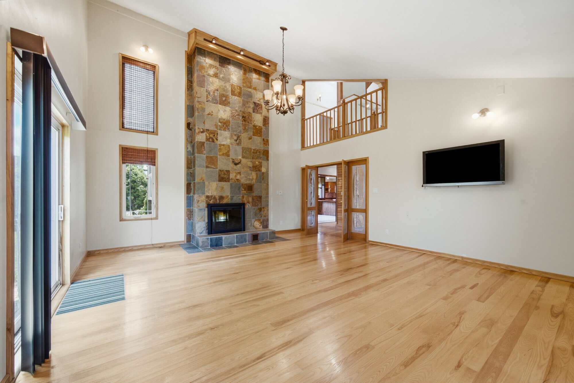 Great room at 17 Ontoro Blvd, South East Ajax, with a floor-to-ceiling stone fireplace and vaulted ceilings