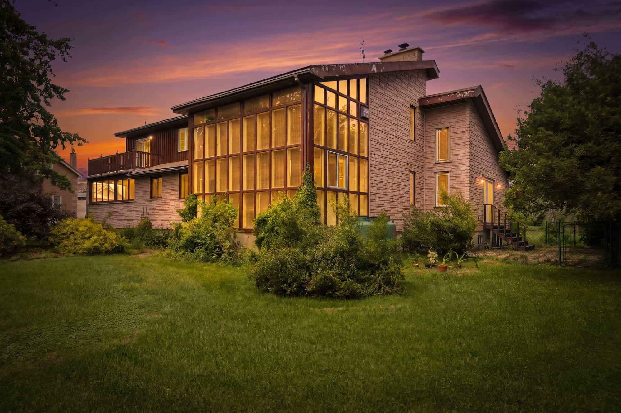 Rear exterior of 17 Ontoro Blvd at dusk, South East Ajax, a custom board-and-batten home on a half-acre lot, listed by Laura McBride, Ajax REALTOR®