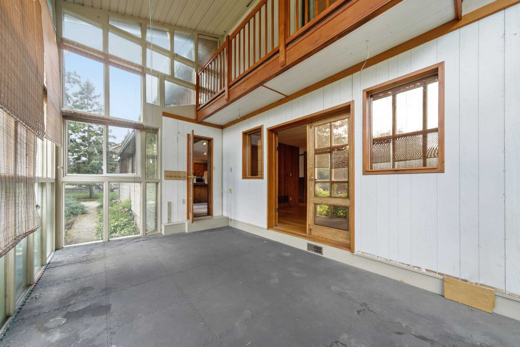 Two-storey glass conservatory at 17 Ontoro Blvd, South East Ajax, wrapped in floor-to-ceiling windows