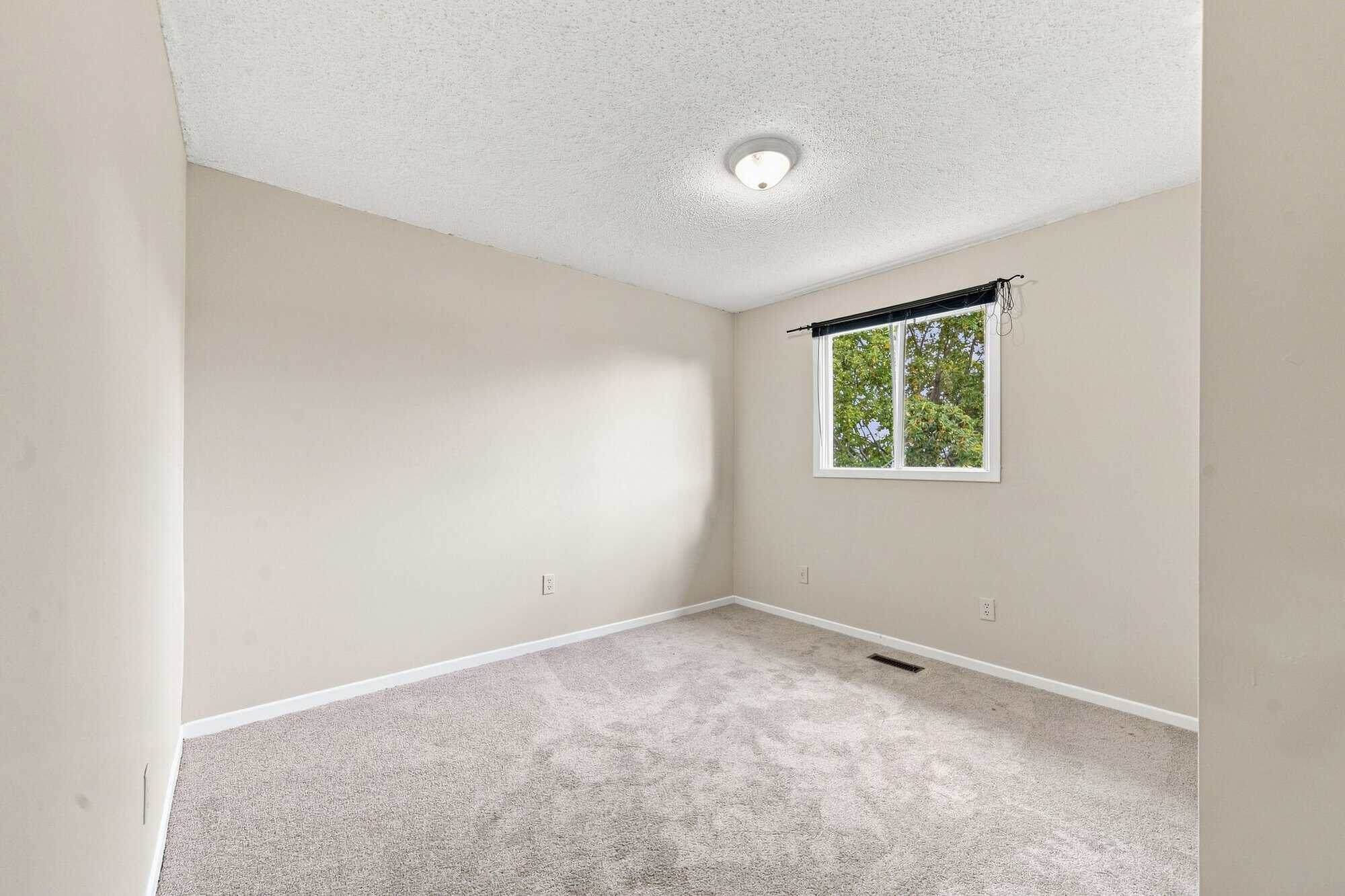 Second bedroom at 22 Kipling Cres, South Ajax, shown unstaged with neutral finishes, listed by Laura McBride, Ajax REALTOR®
