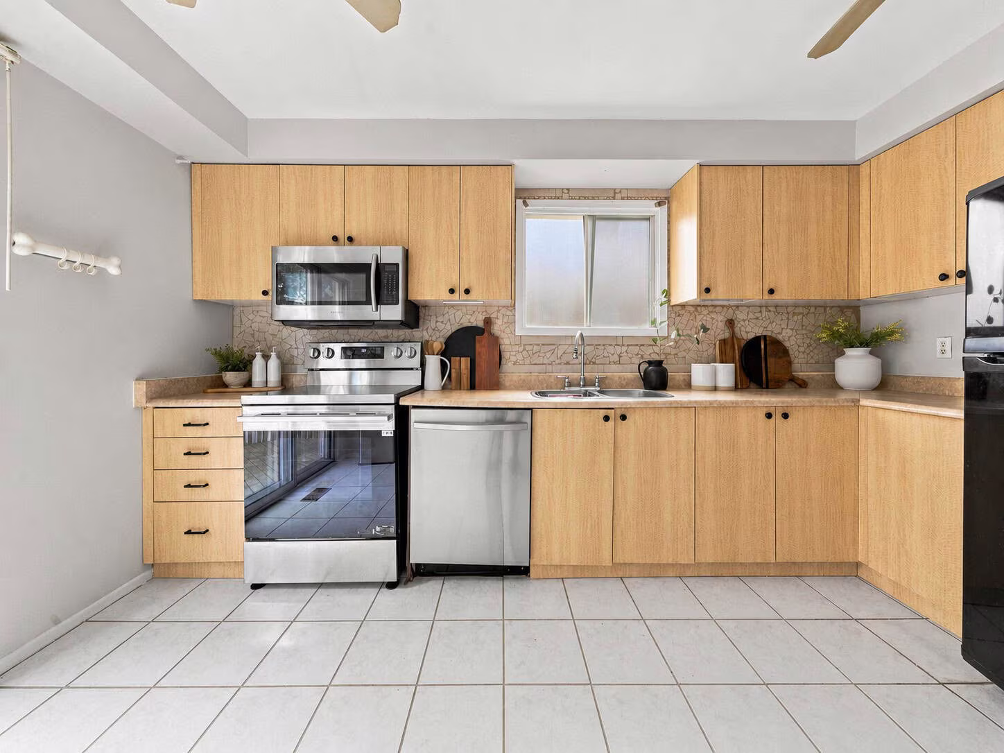 Kitchen at 22 Kipling Cres, South Ajax, with tile flooring, ample cabinetry and sliding doors to the rear deck, listed by Laura McBride, Ajax REALTOR®