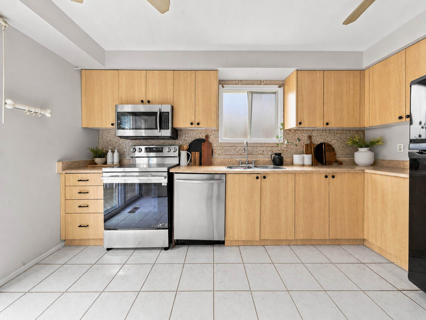 Kitchen at 22 Kipling Cres, South Ajax, with tile flooring, ample cabinetry and sliding doors to the rear deck, listed by Laura McBride, Ajax REALTOR®