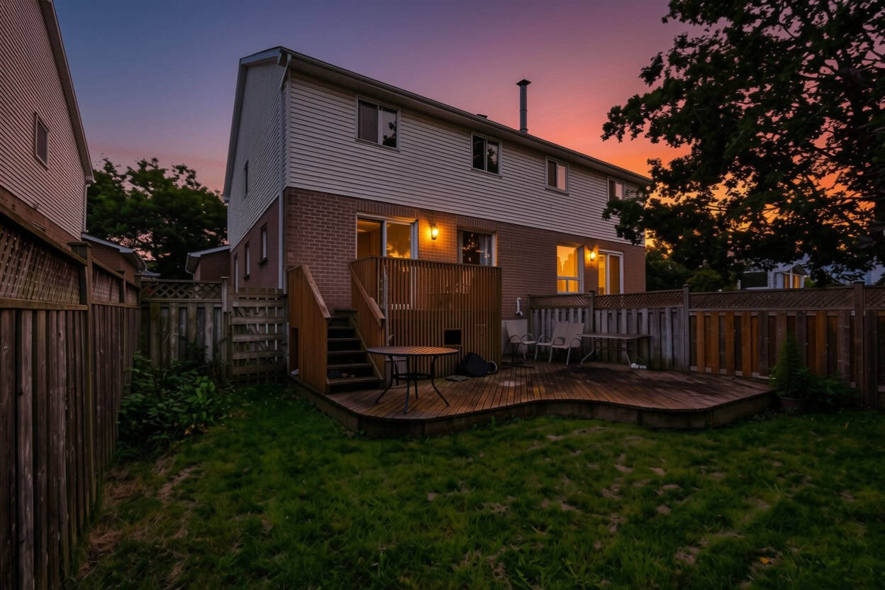 Rear exterior of 22 Kipling Cres, South Ajax, at twilight with the fenced yard and mature trees, listed by Laura McBride, Ajax REALTOR®