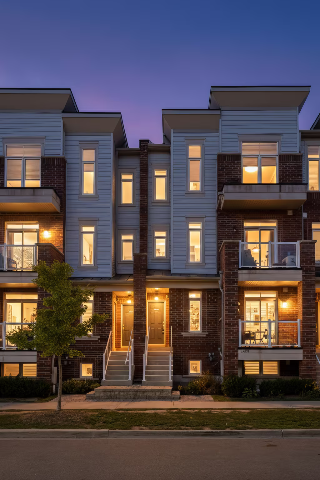 Exterior of 2598 William Jackson Dr, Pickering, a brick stacked townhouse at sunset, sold by Laura McBride, Ajax REALTOR® with Revel Realty
