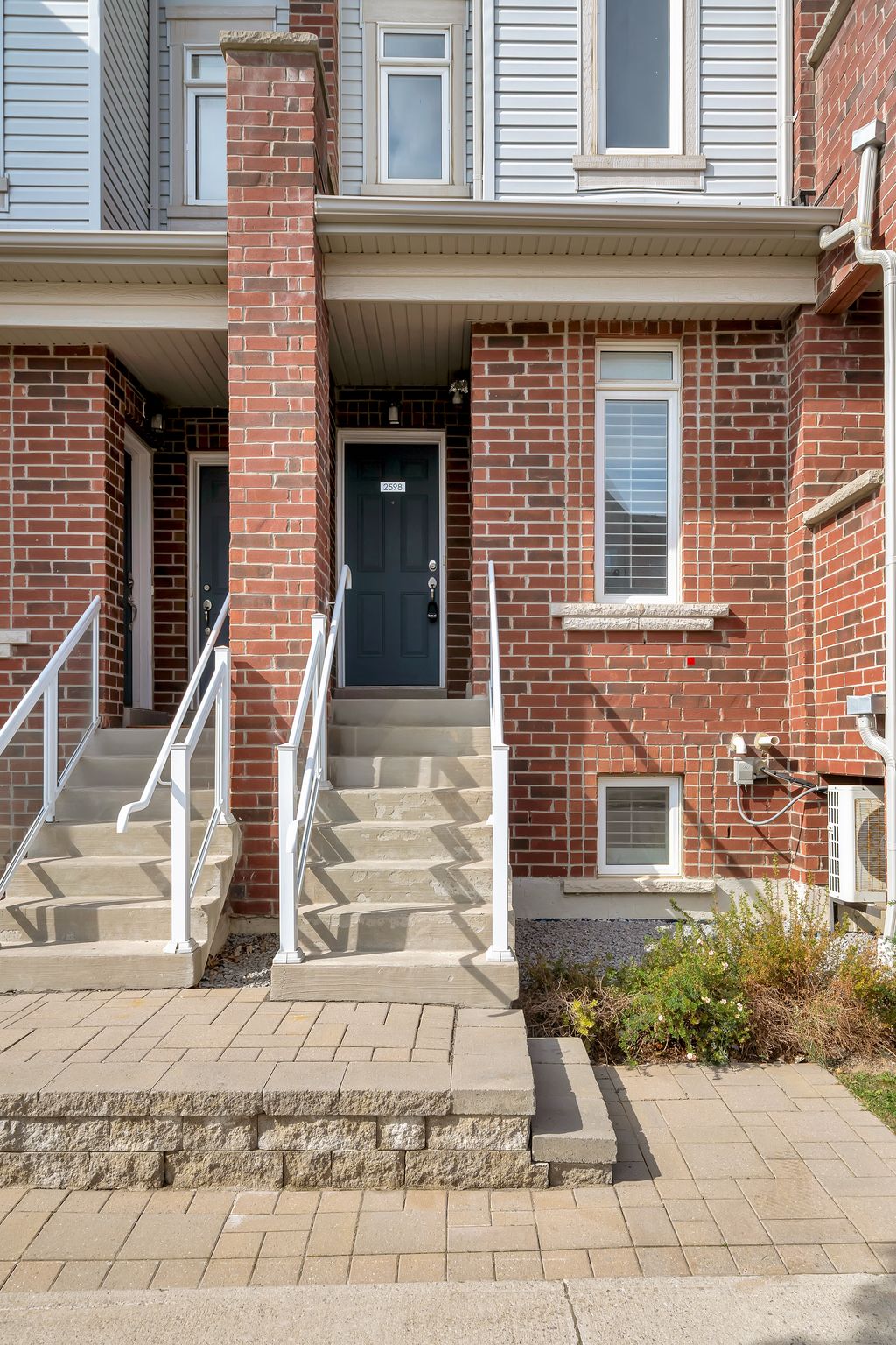 Front entryway at 2598 William Jackson Dr, Pickering, with a brick facade and covered steps