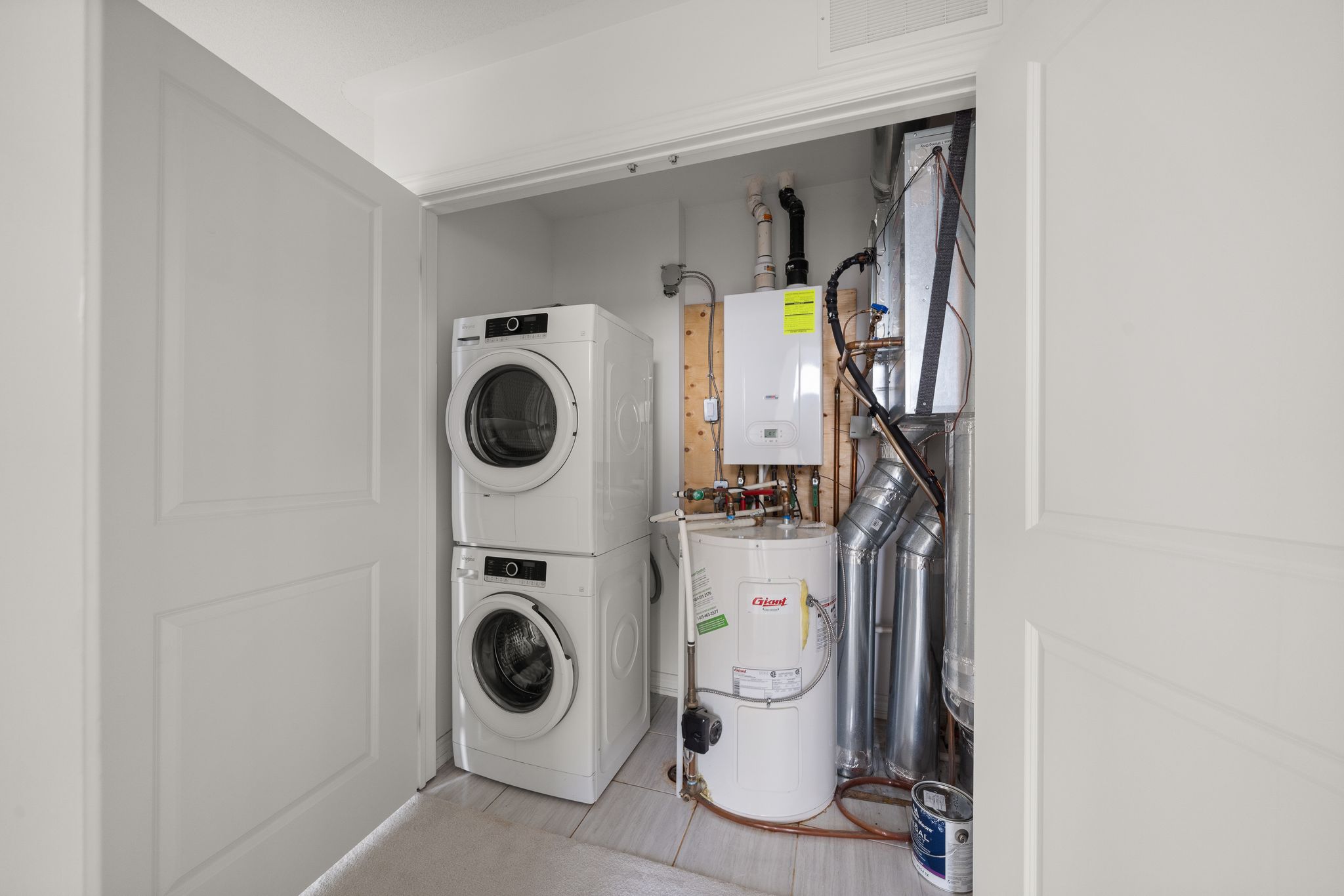 Ensuite laundry closet at 2598 William Jackson Dr, Pickering, with stacked washer and dryer