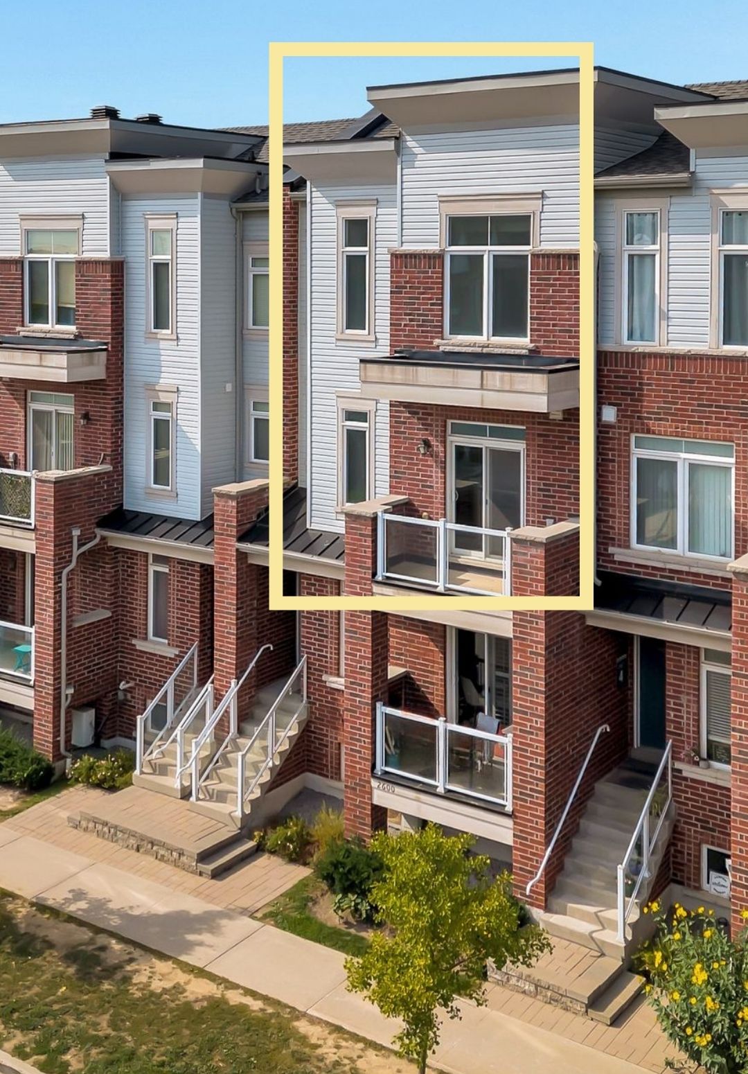Street-level photo of the stacked townhouse building at 2598 William Jackson Dr, Pickering, with unit 87 outlined