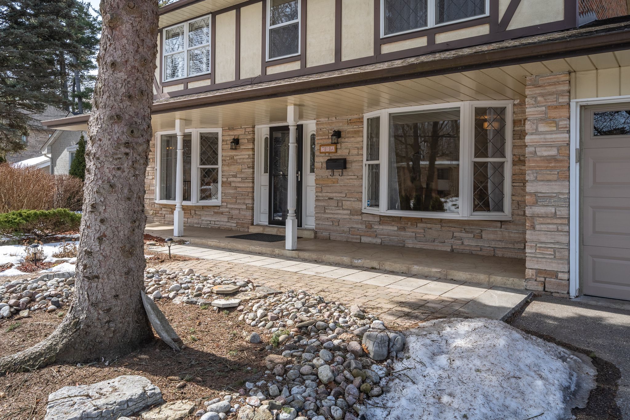 Front entrance at 38A Deep Dene Dr, Highland Creek Village, with a stone and brick facade