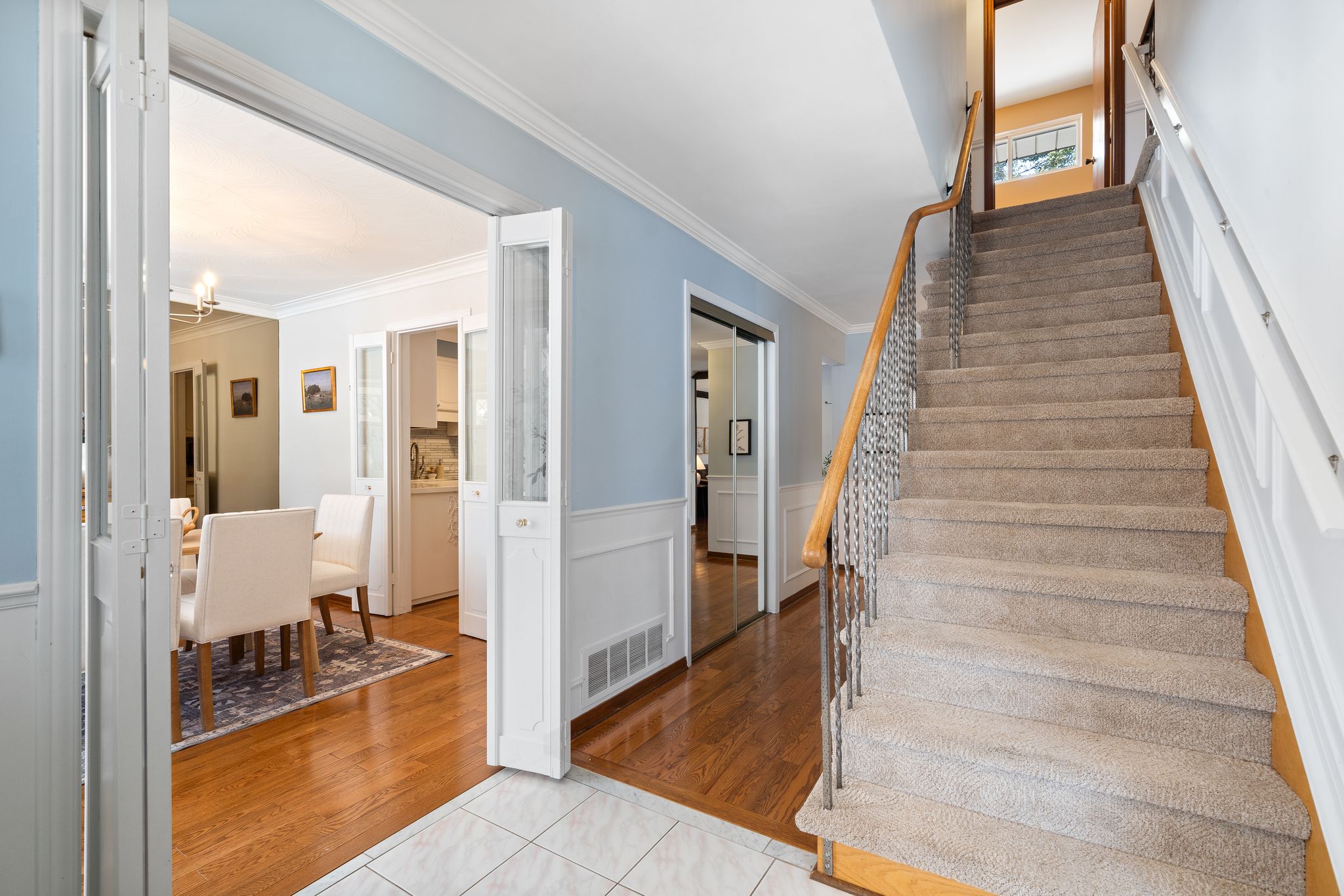 Entry hall staircase at 38A Deep Dene Dr, Highland Creek Village, with a view into the dining room